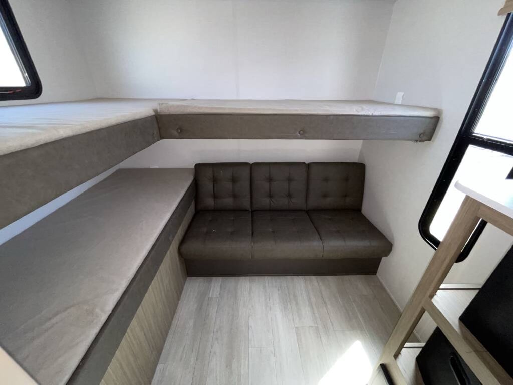 Inside an RV rental: versatile bunk beds and a comfortable sofa provide flexible sleeping and living space.. Forest river Salem Cruise lite 2025