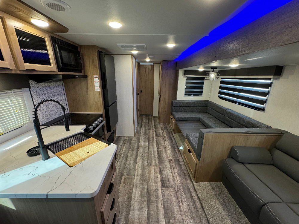 Experience comfort in this modern RV rental! Features a full kitchen with large sink, dinette, and cozy living area. Perfect home on wheels.. Forest River Alpha Wolf 280 QBS-L 2024