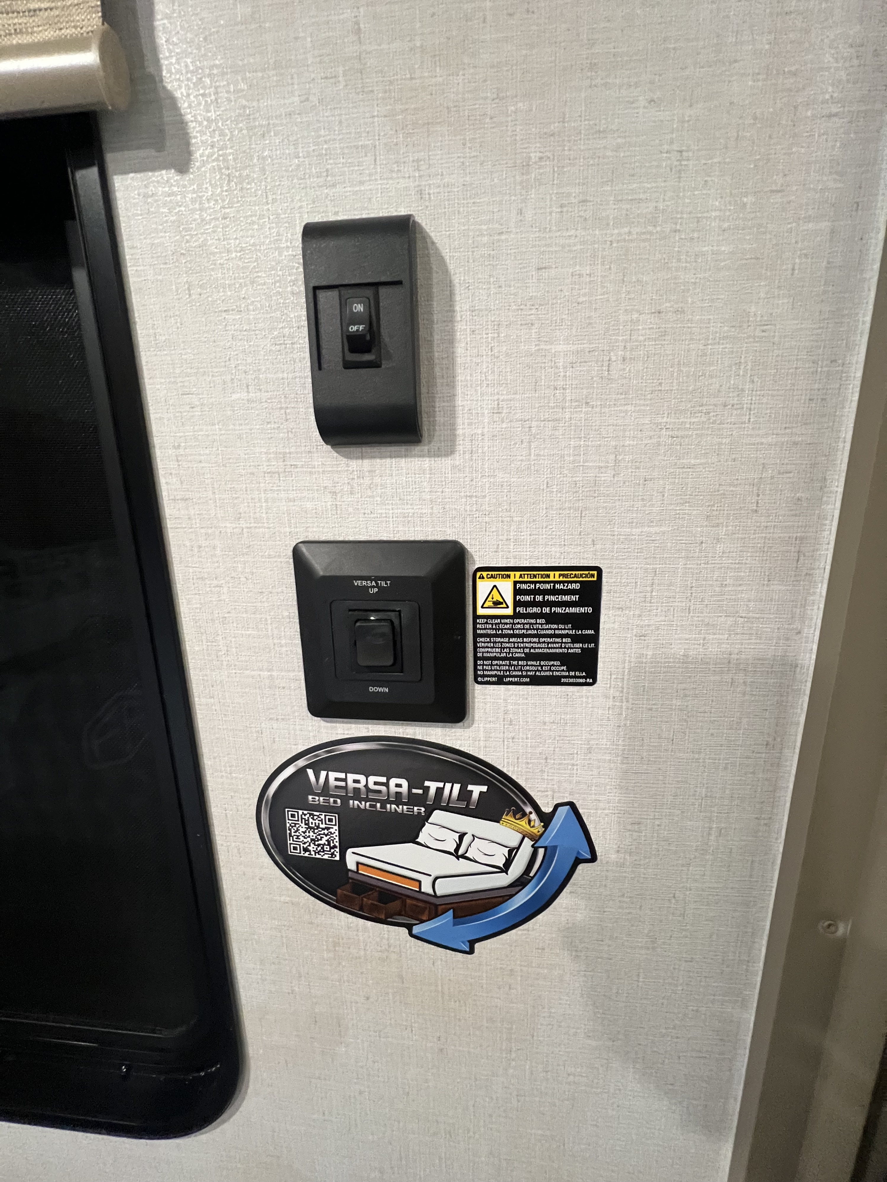 RV rental: Interior wall with Versa-Tilt bed incliner controls, an ON/OFF switch, and a pinch point hazard warning.. Forest River 28VBXLX 2025