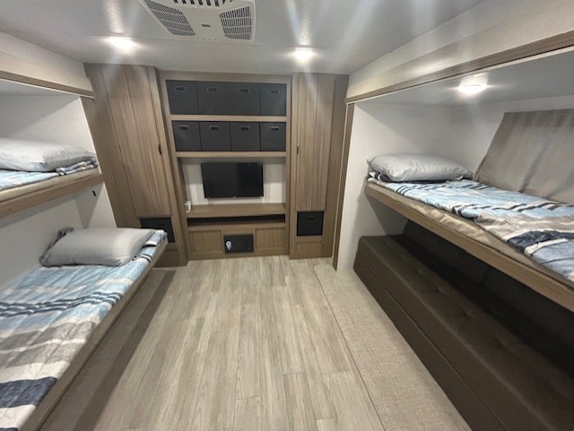 RV rental bunkhouse: Cozy interior with two sets of bunks, TV, and ample storage for family adventures.. Forest River Salem 2025