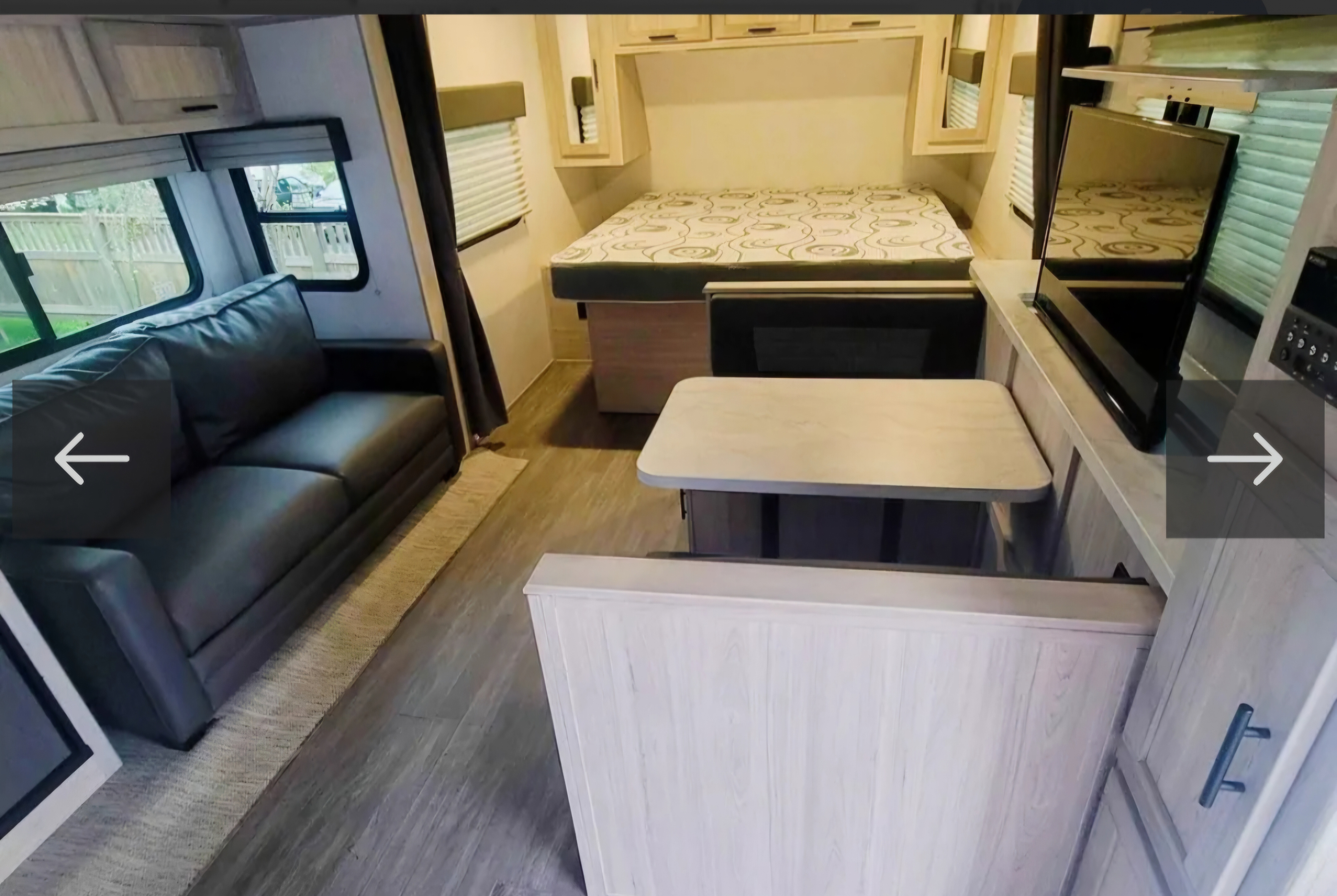 Spacious rv rental interior features a comfy sofa, dining area, and queen bed for your adventures.. Forest River Shadow Cruiser 2022