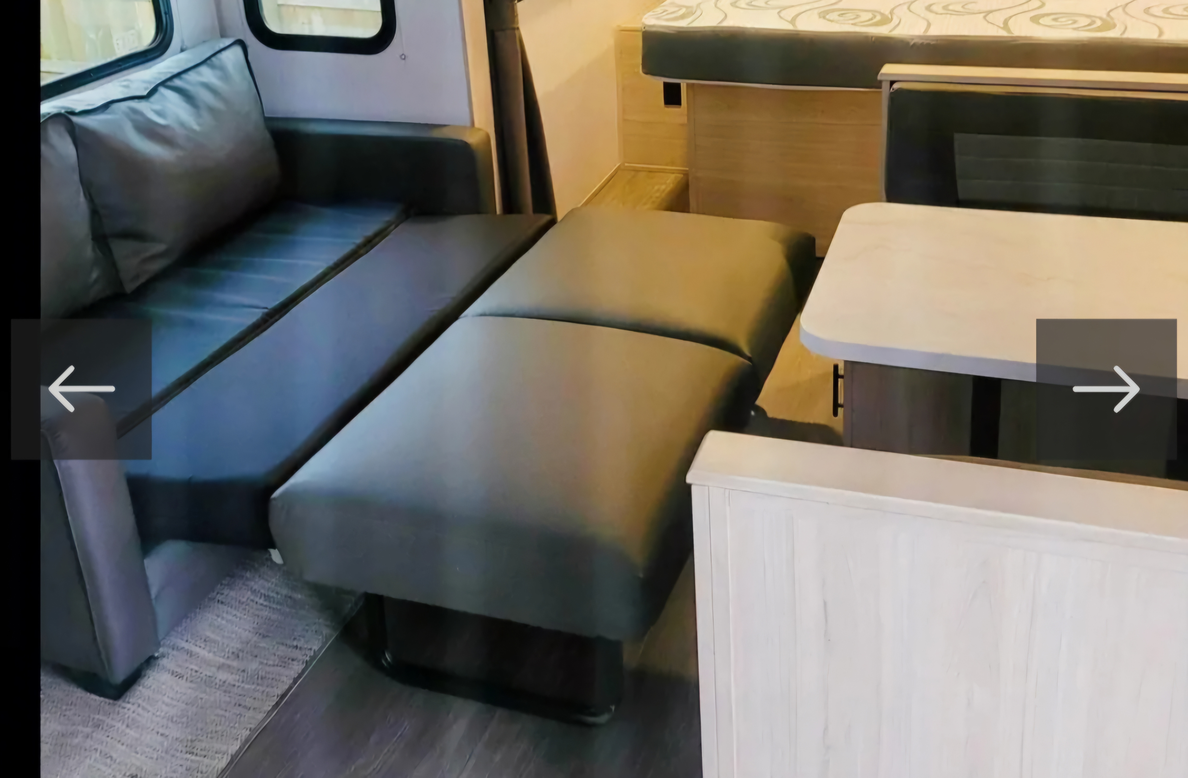 RV rental: Versatile interior with a pull-out sofa bed (dark grey cushions), a light dining table, and compact living space.. Forest River Shadow Cruiser 2022