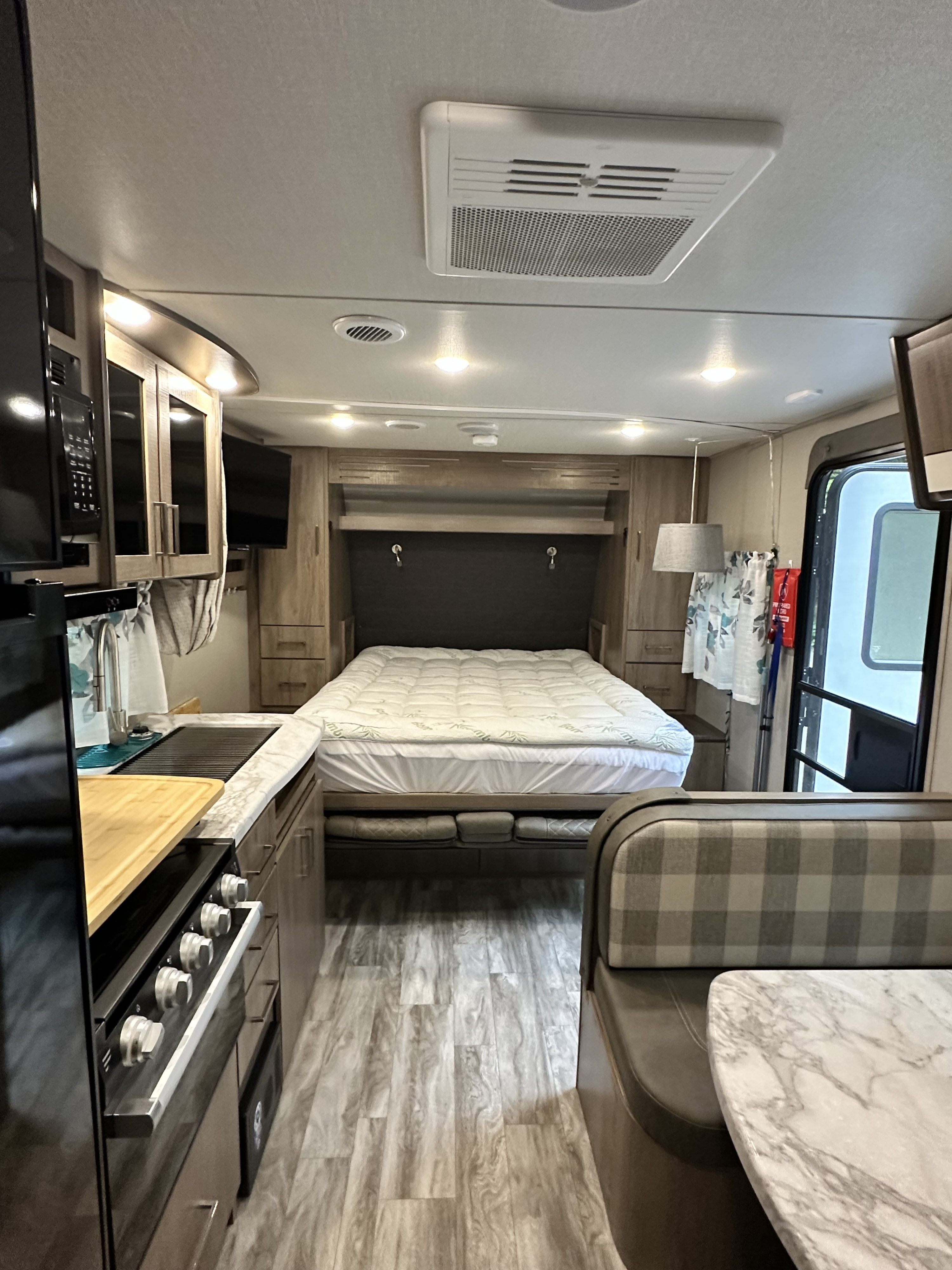 Step inside this modern RV rental featuring a comfortable bed, full kitchen, and spacious dinette for your travels.. Grand Design Imagine XLS 2022