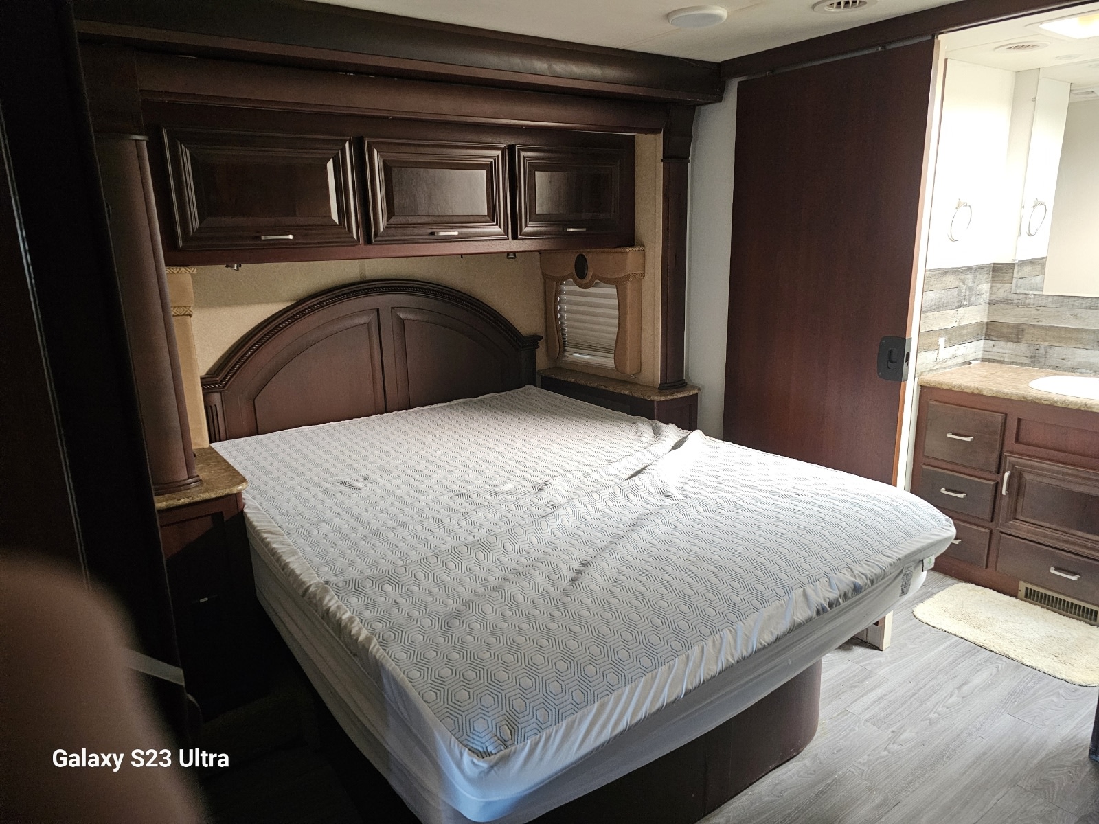 Comfortable RV rental bedroom with a large bed, ample storage, and convenient attached bathroom.. Damon Corporation Challenger 2011