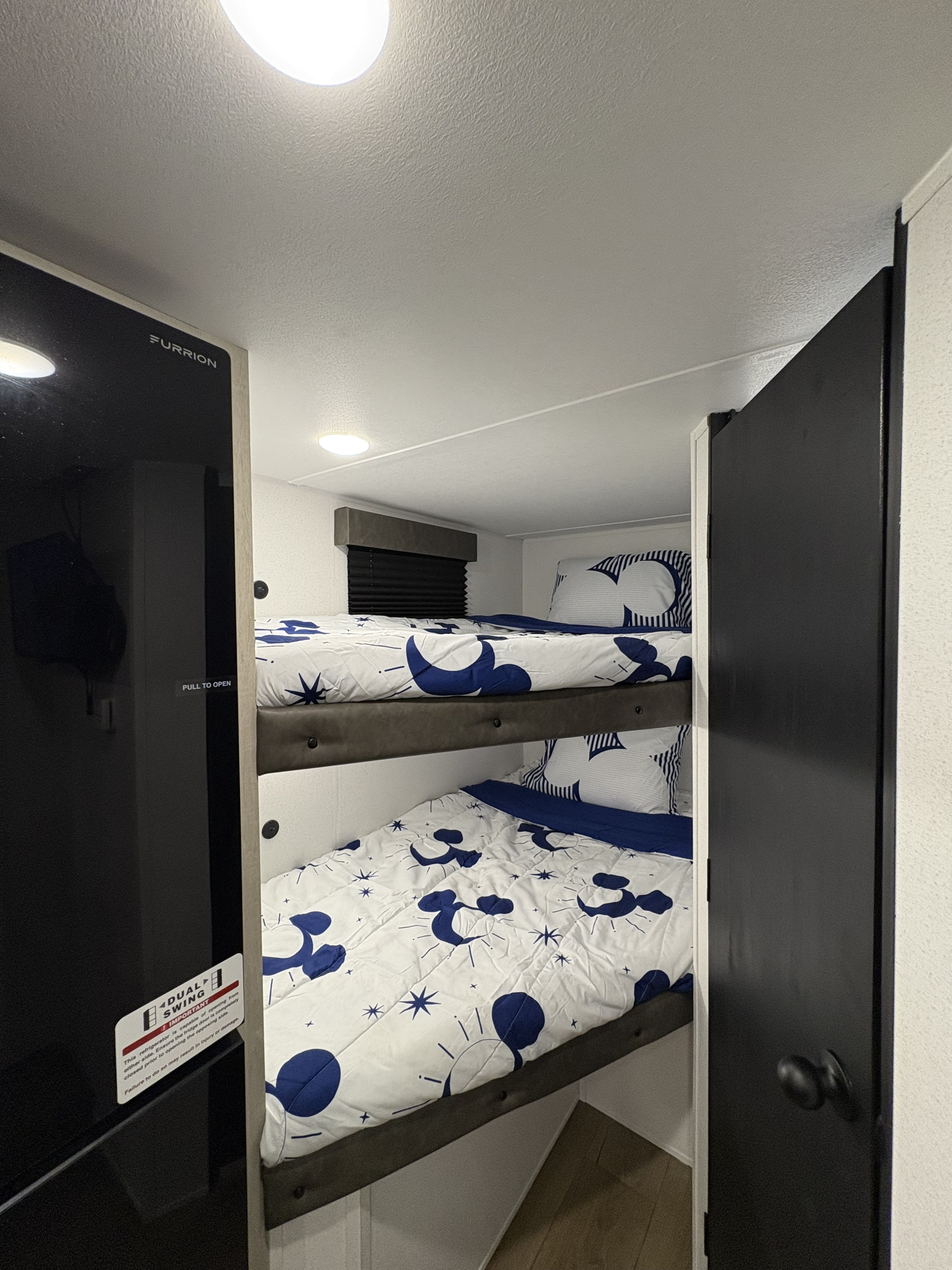 RV rental with comfy bunk beds (Mickey-like design) and a Furrion dual-swing refrigerator, maximizing space.. Forest River Puma 2025