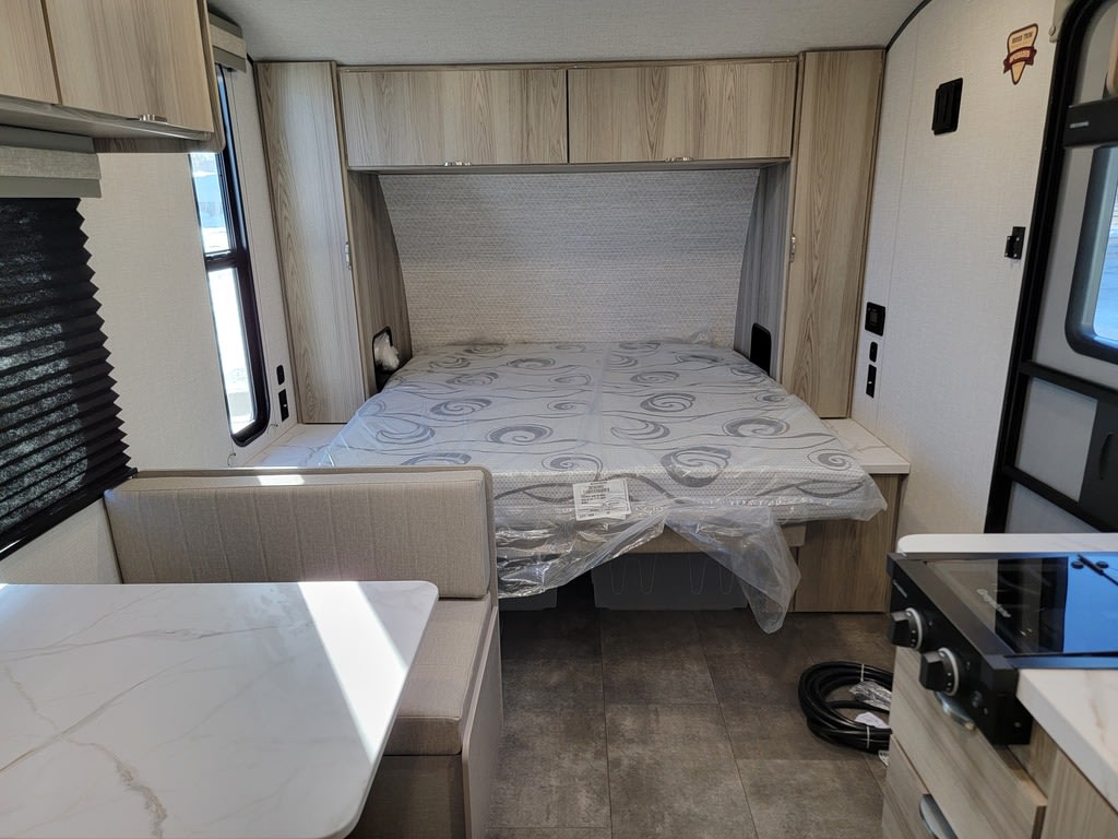 Spacious RV rental interior featuring a comfortable bed, dinette seating, and a compact kitchen area.. Forest River Salem FSX 177BH 2025