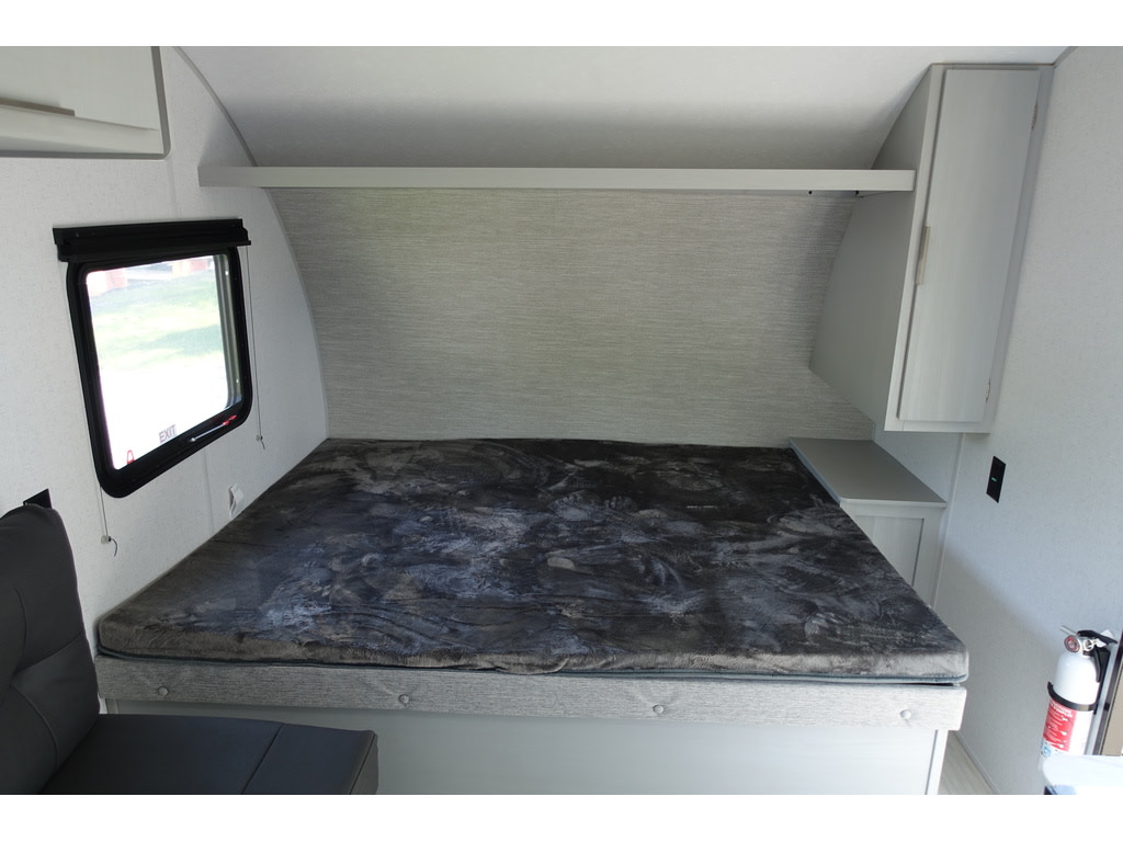 Cozy sleeping area in this RV rental, with a comfortable bed, window, and built-in storage for your adventure.. Forest River Salem FSX 174BHLE 2024