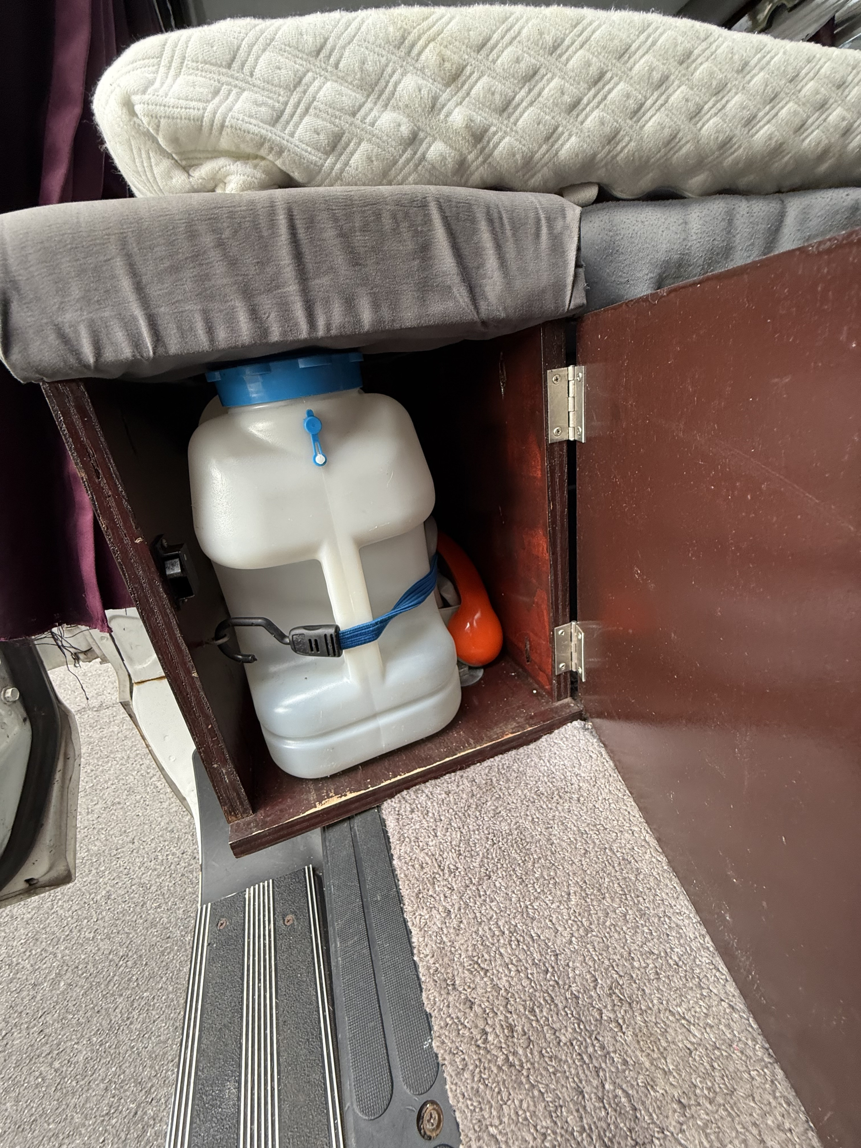 RV rental interior: Organized storage for water & bedding in a camper van. Ready for your next journey.. Dodge Ram 1500 2000