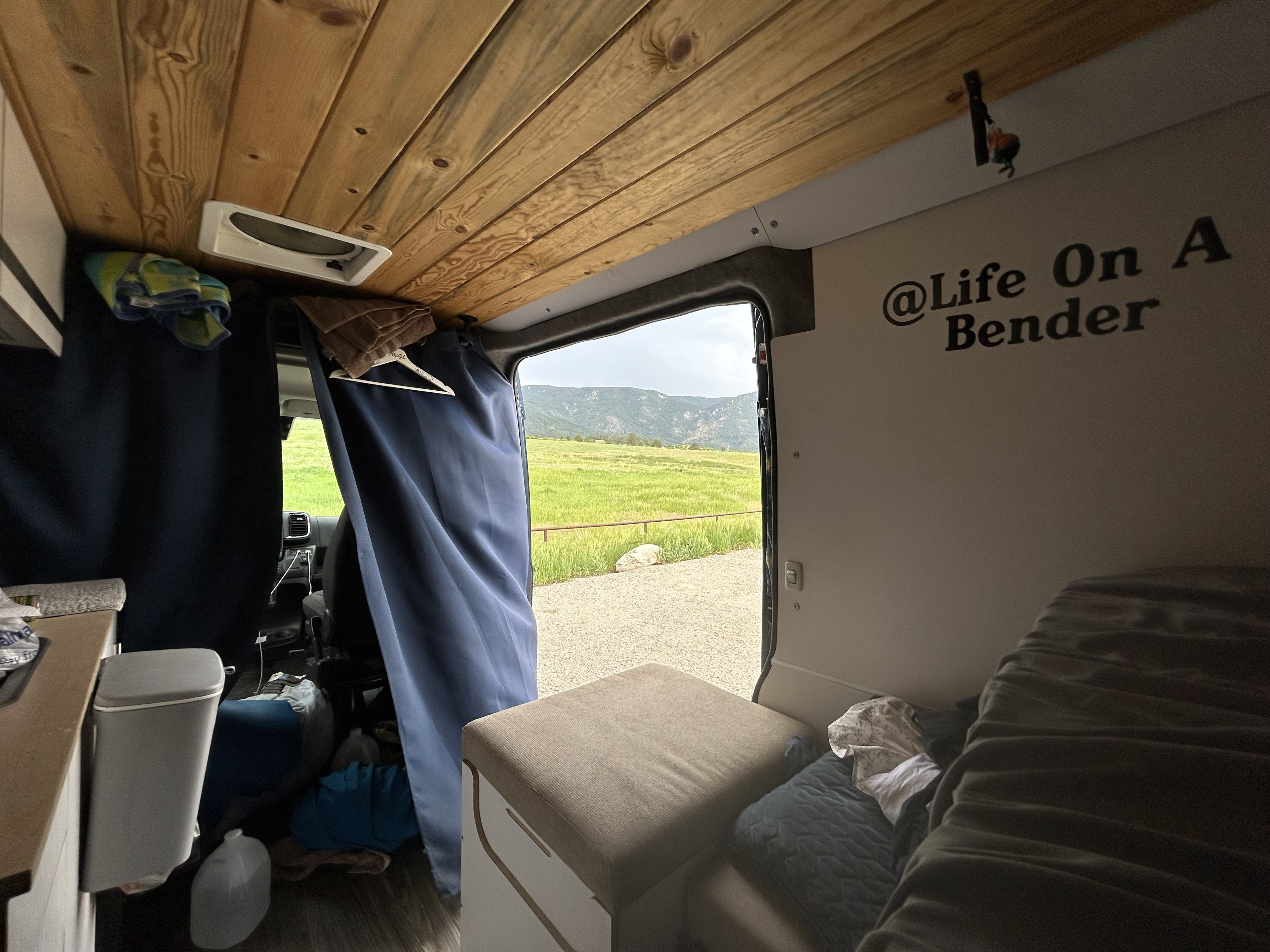 Enjoy the outdoors from this RV rental! Cozy camper van interior with wooden ceiling and scenic mountain view.. Dave & Matt Vans Dave & Matt Vans Class B 2022