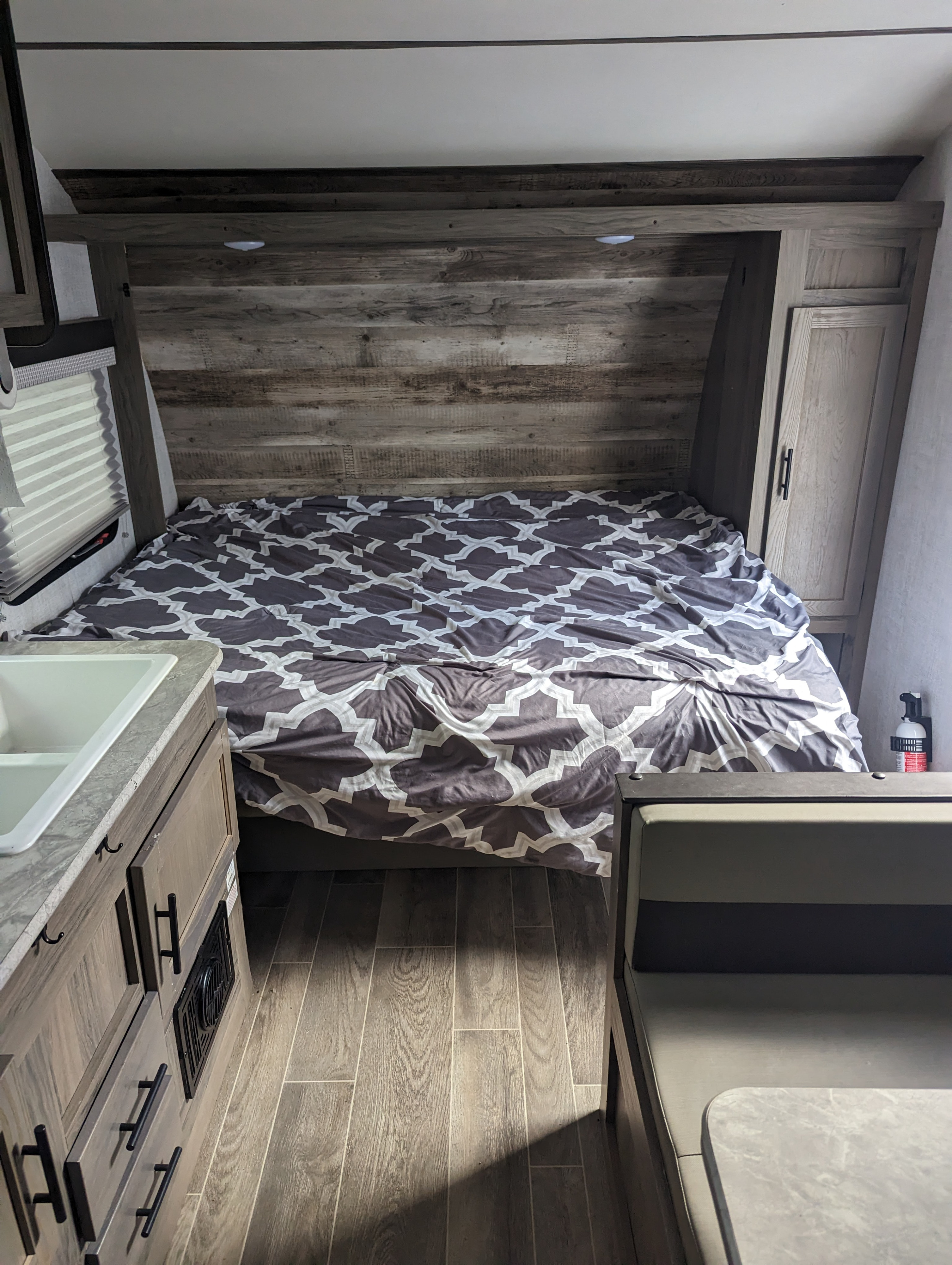 RV rental: View of the bed, kitchen sink, and dinette area inside a modern travel trailer.. Gulf Stream Innsbruck Super Lite 2021