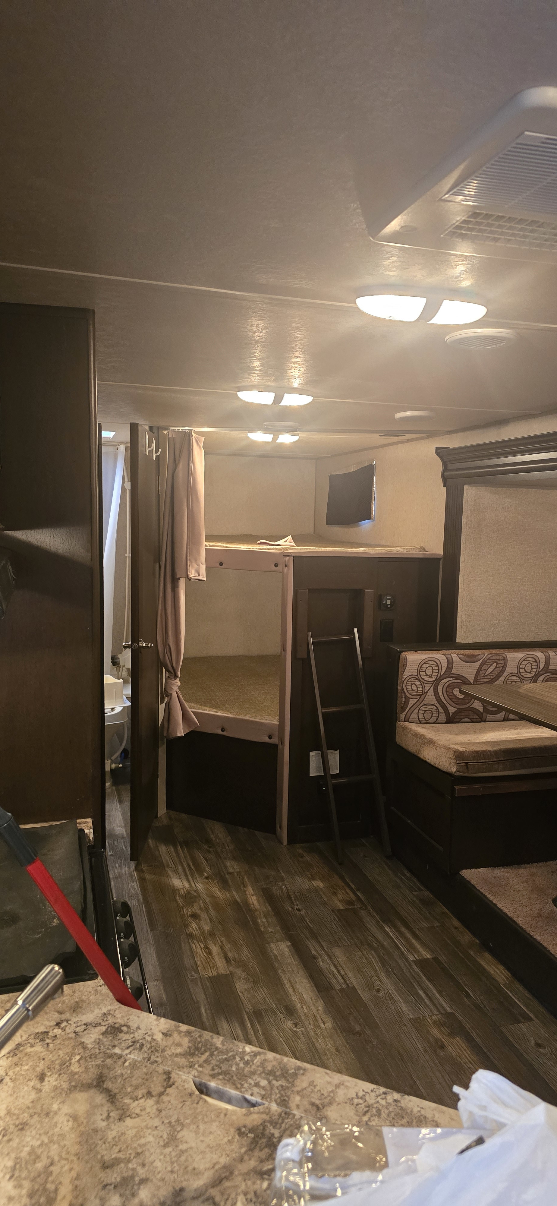 RV rental living area showing bunk beds, dinette, kitchen counter, and bathroom.. Forest River Cherokee 2016