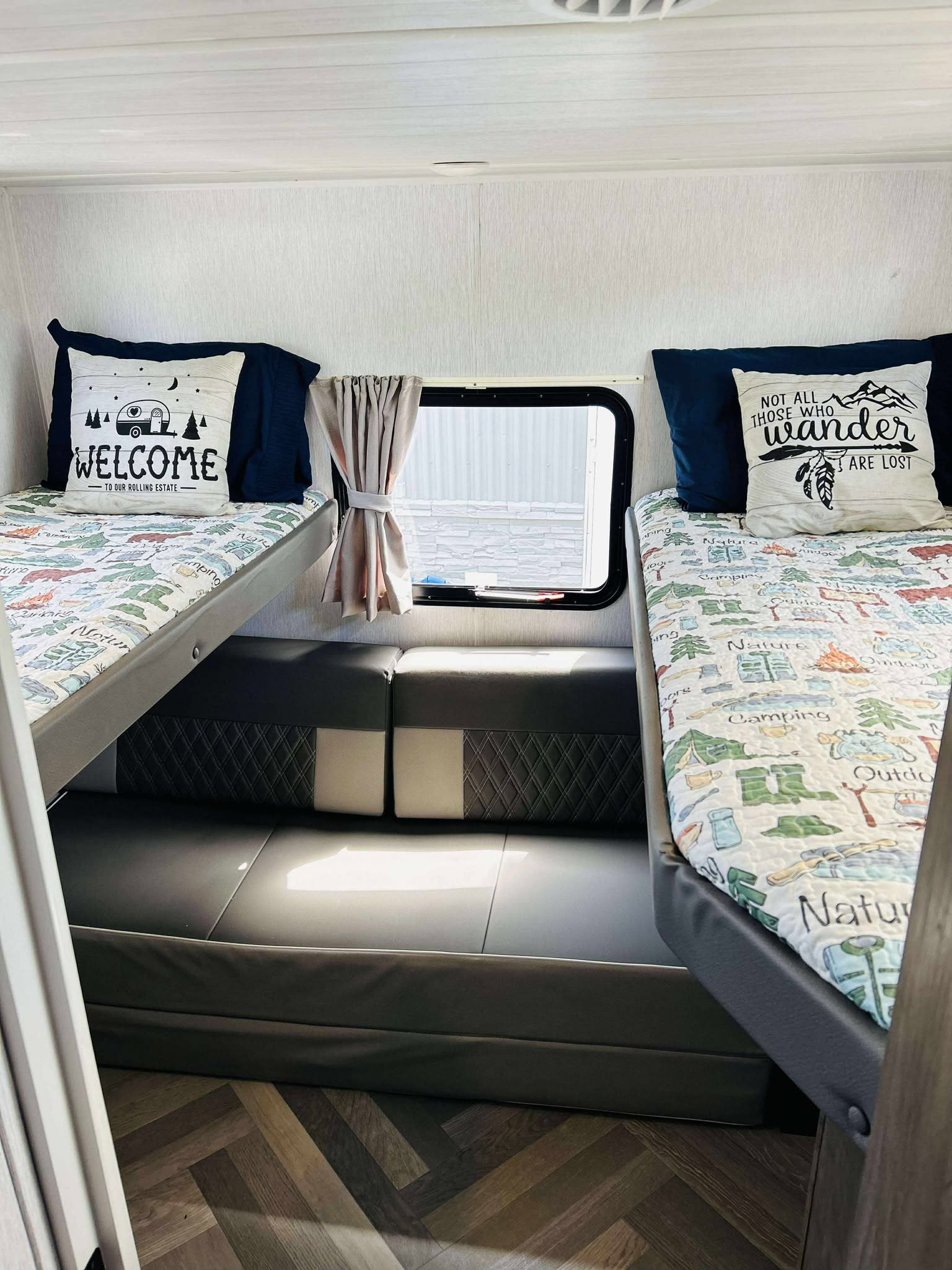 Cozy rv rental interior: twin bunk beds with camping-themed pillows & blankets, perfect for family travel.. Forest River Salem Cruise Lite 2022