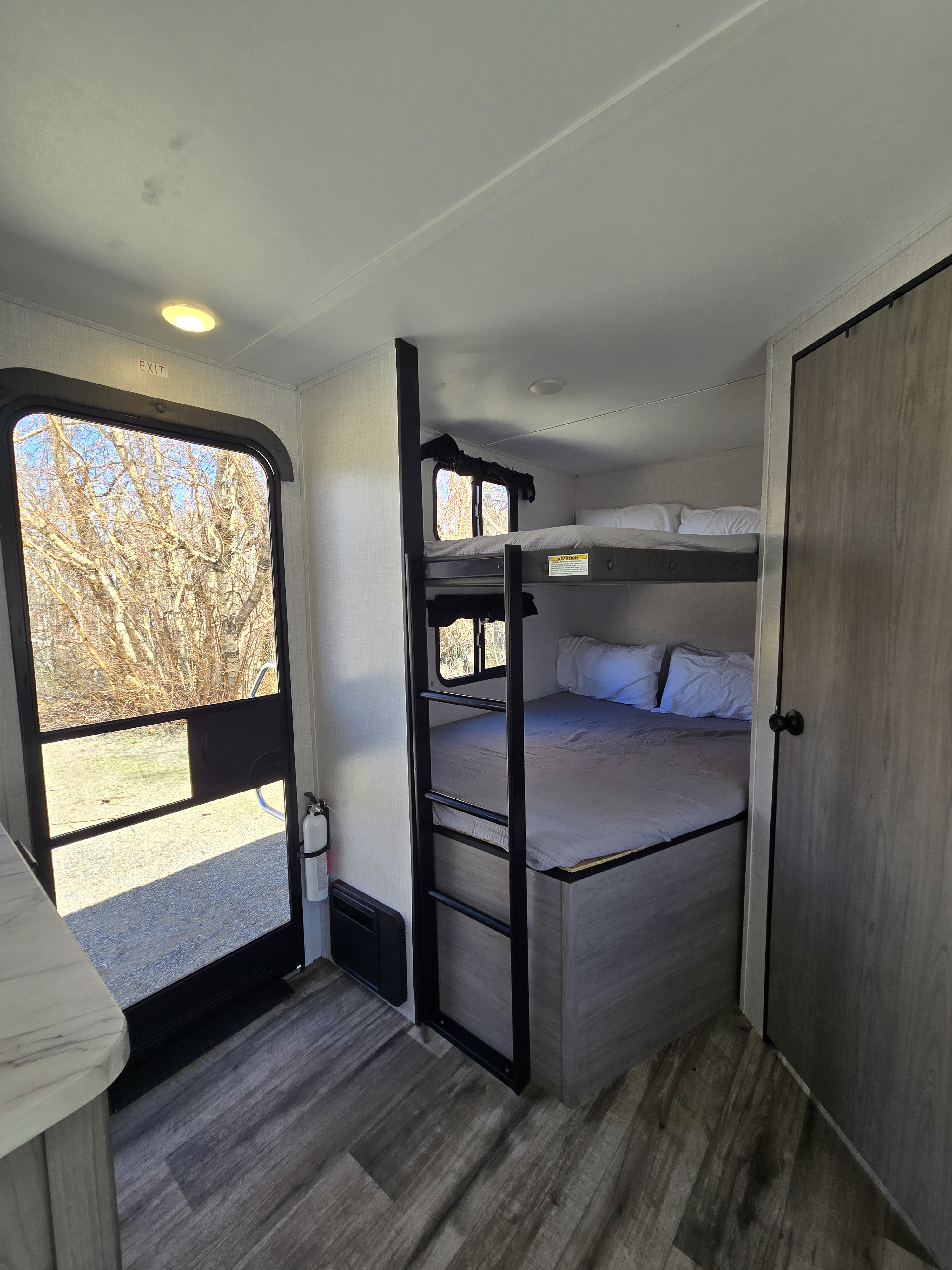 Spacious RV rental bunkhouse features comfy bunk beds, ample sleeping space, and an exit door, ideal for family adventures.. Coleman Lite Series 2755BH 2022