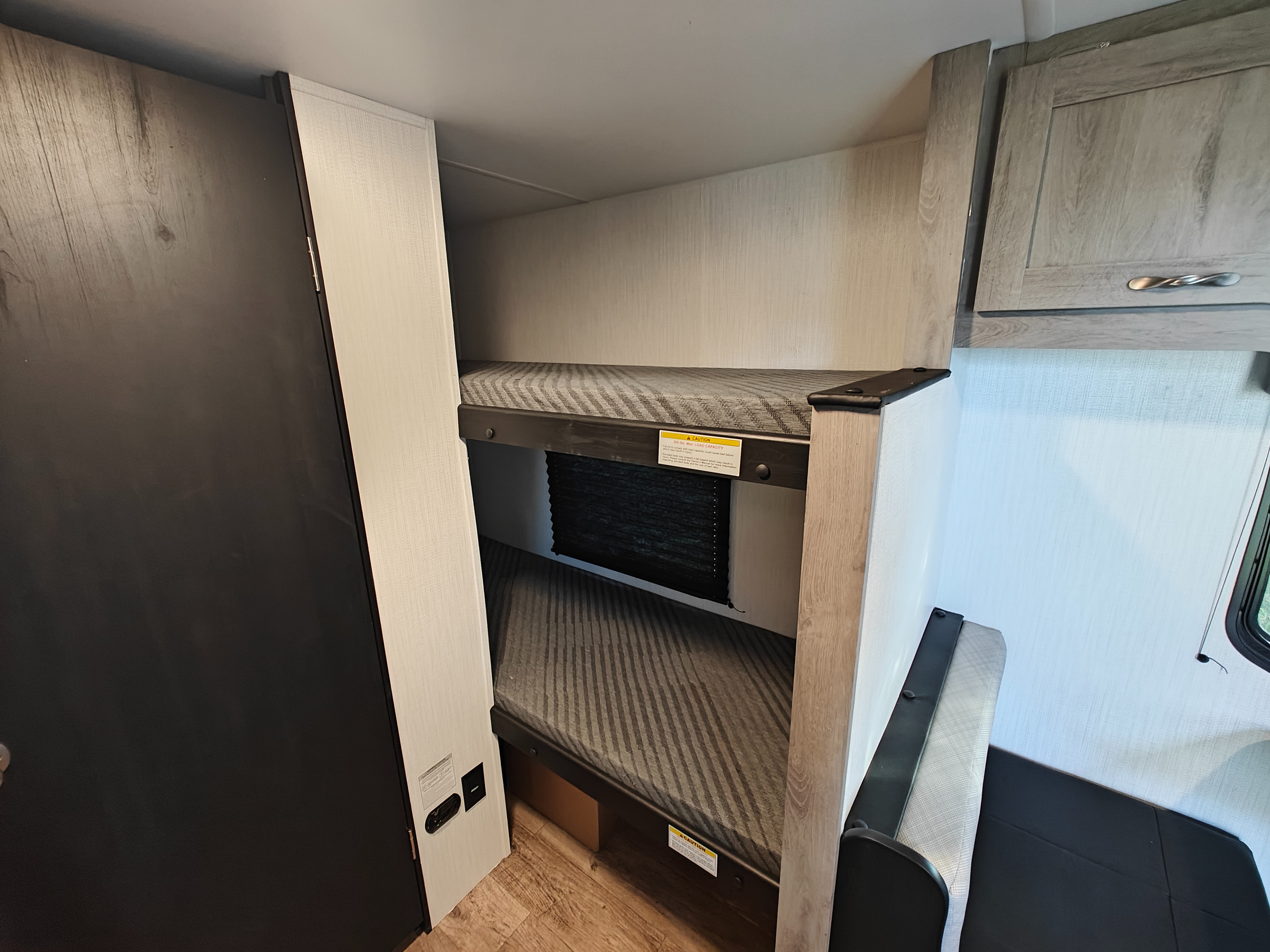 Cozy RV rental interior with comfortable bunk beds for extra sleeping space, perfect for family adventures.. Cruiser Avenir 17BH Travel Trailer Avenir 17BH 2025