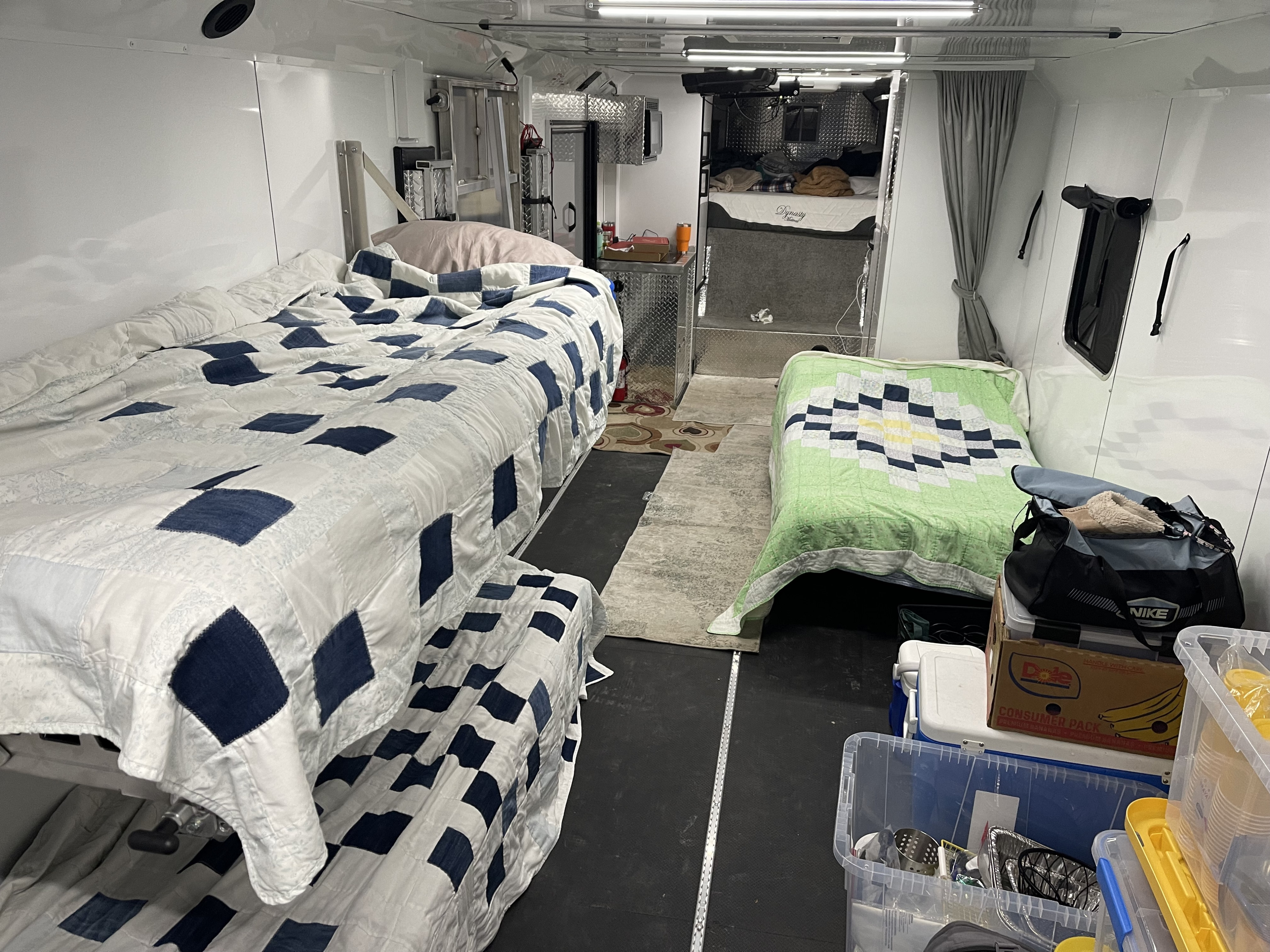 Inside an RV rental: cozy living space with beds, kitchenette, and storage.. Trailswest RPM Freeride 34 2022