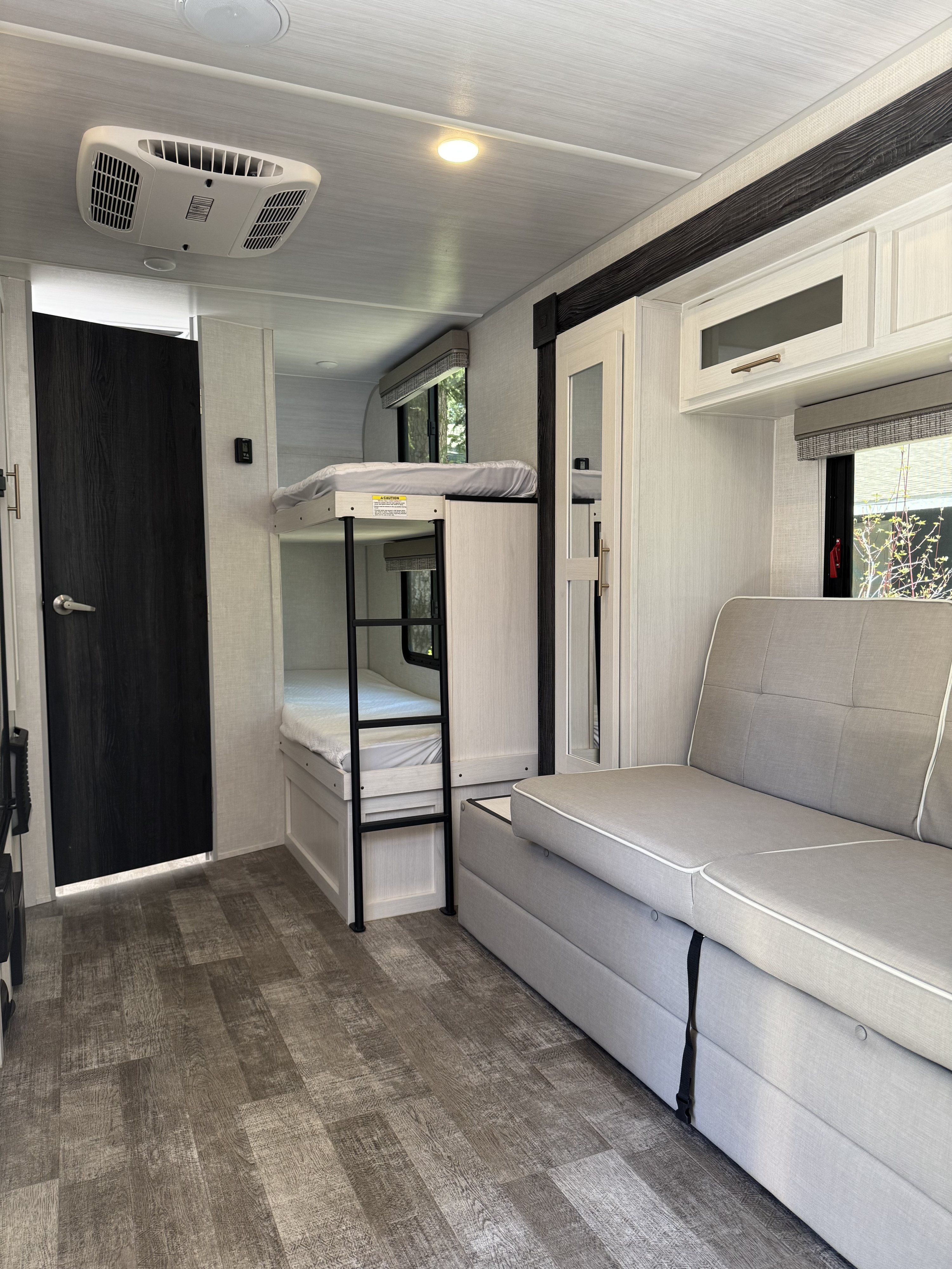 Step inside this modern RV rental: includes bunk beds, a comfortable sofa, and durable wood-look flooring.. Forest River r-pod 193 2022