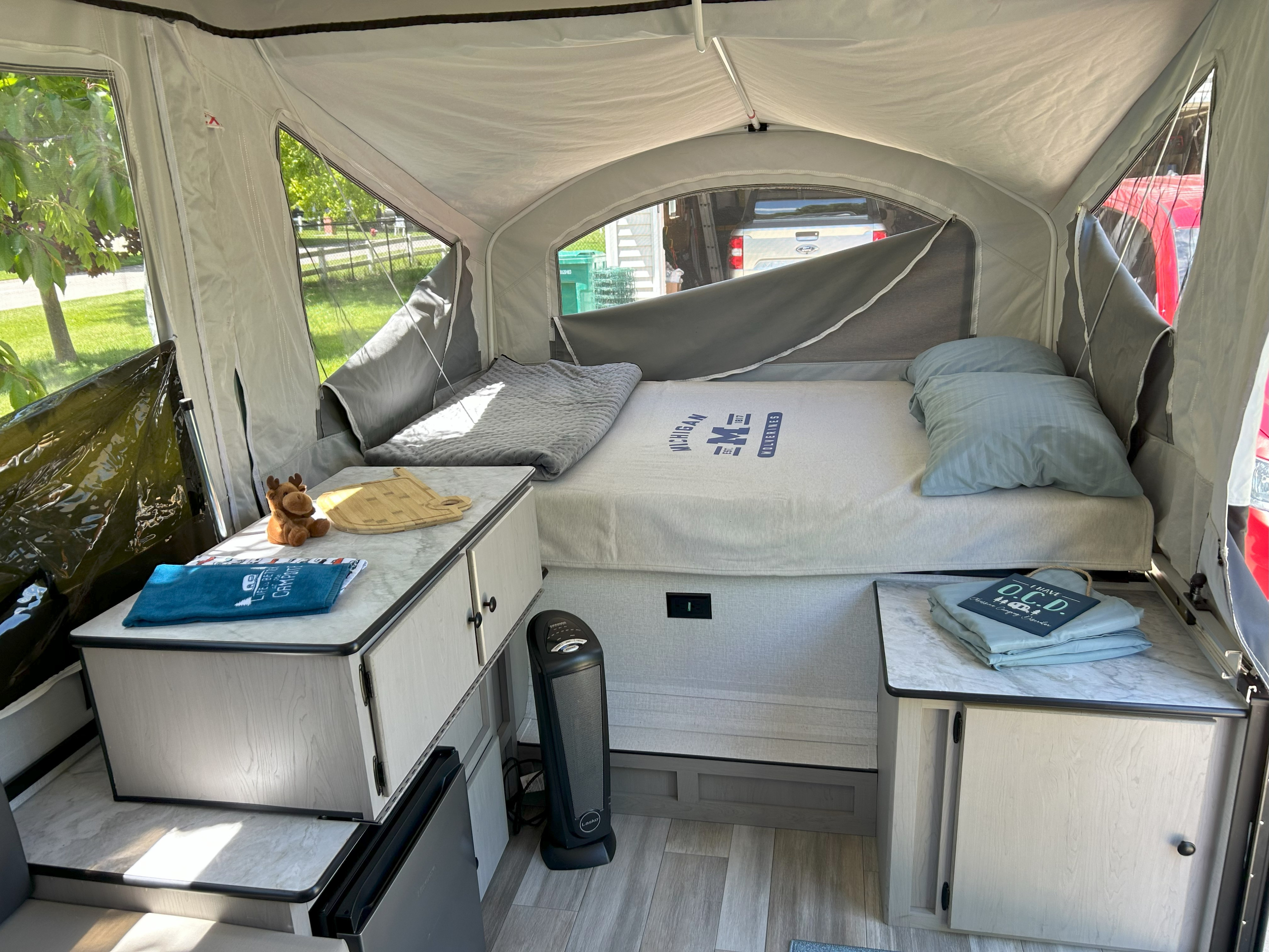 Step inside this cozy **rv rental**'s organized interior, featuring a comfortable bed, cabinets, and thoughtful camping decor.. Coachmen Clipper 806XLSLE Clipper 2024