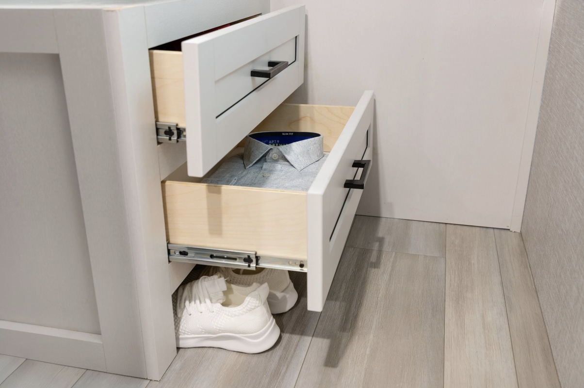 RV rental interior: White pull-out drawers show storage, holding a shirt, with sneakers beneath.. Go Play 26BHS 2025