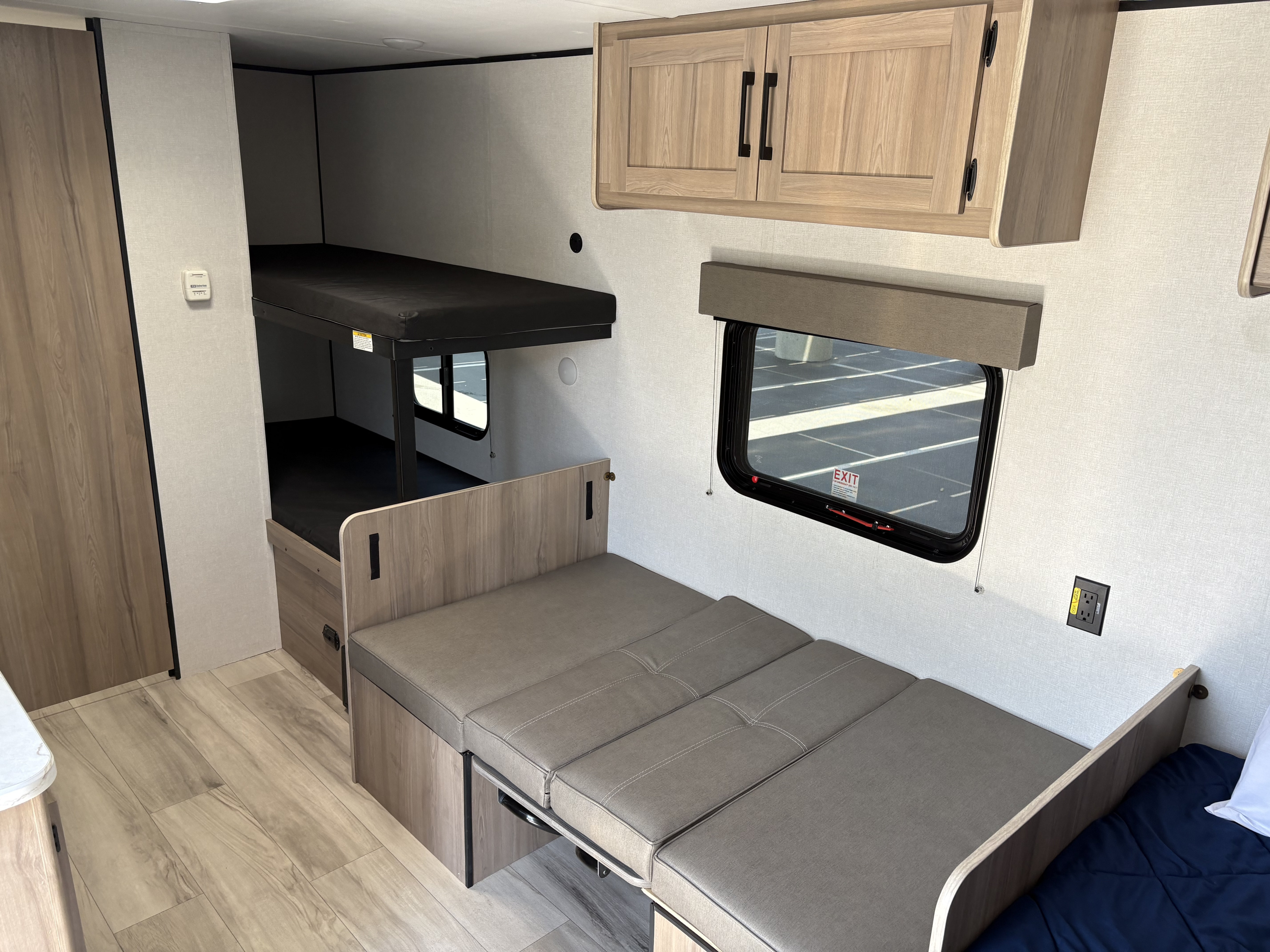 Spacious RV rental interior with bunk beds, convertible sofa, and modern amenities, perfect for family travel.. Coleman 17B 2025