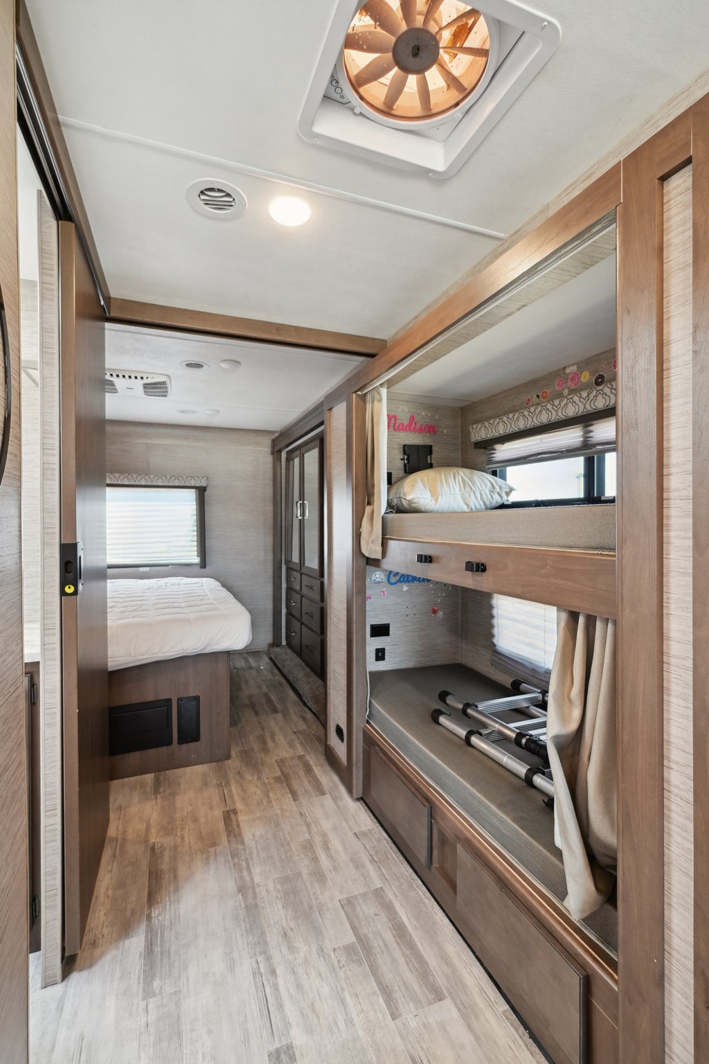 Spacious RV rental interior features a cozy bedroom and family-friendly bunk beds, perfect for comfortable travel.. Thor Freedom Traveler 2022