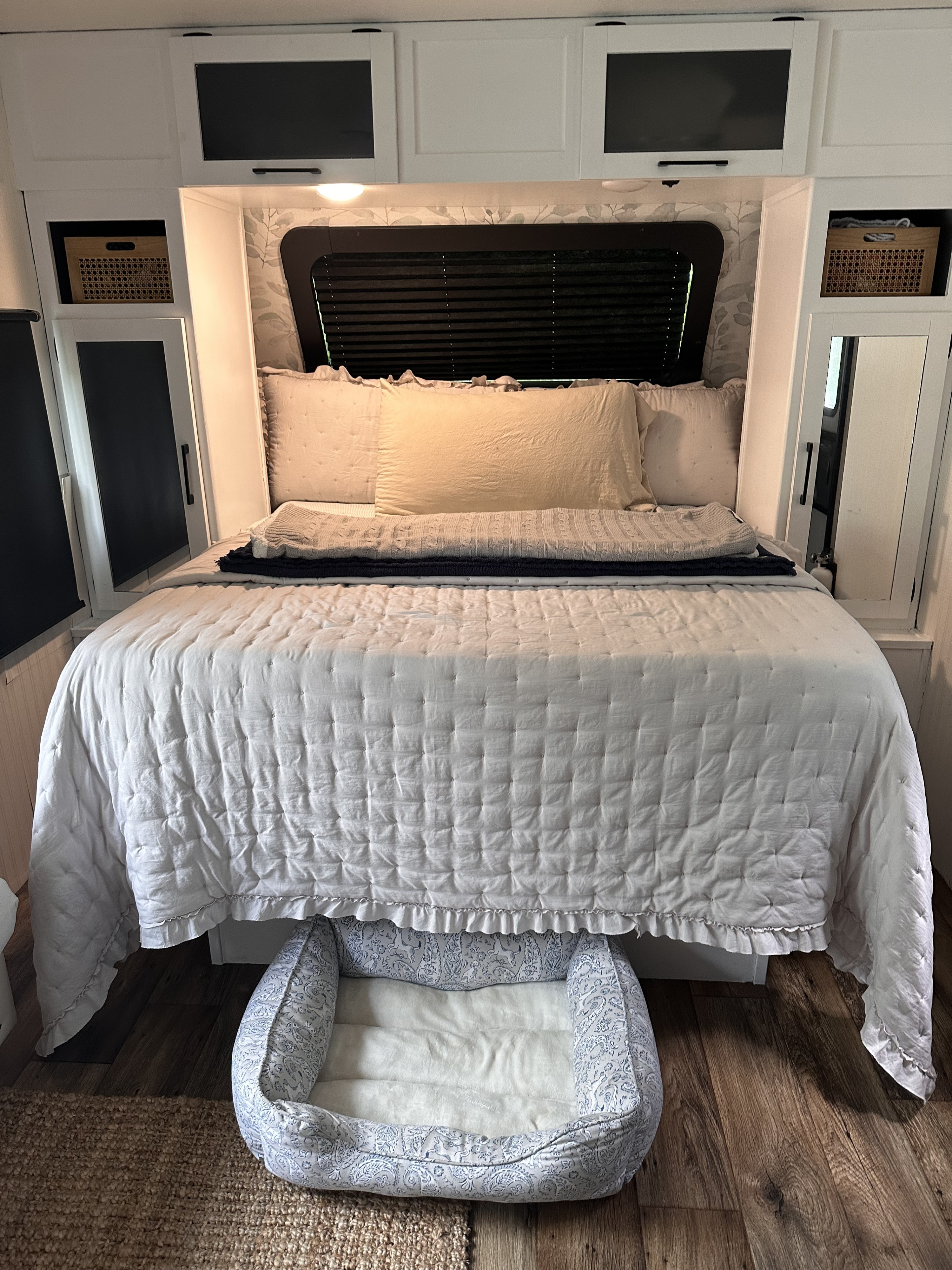 Experience comfort in this RV rental bedroom: a cozy bed, ample storage, and a welcoming dog bed.. Dutchmen Kodiak Cub 2022