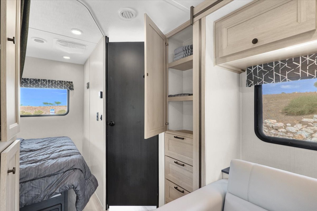 RV rental interior featuring a cozy bedroom, ample storage, and comfortable seating, with views of the outdoors.. Forest River Sunseeker 2550 DSLE 2025