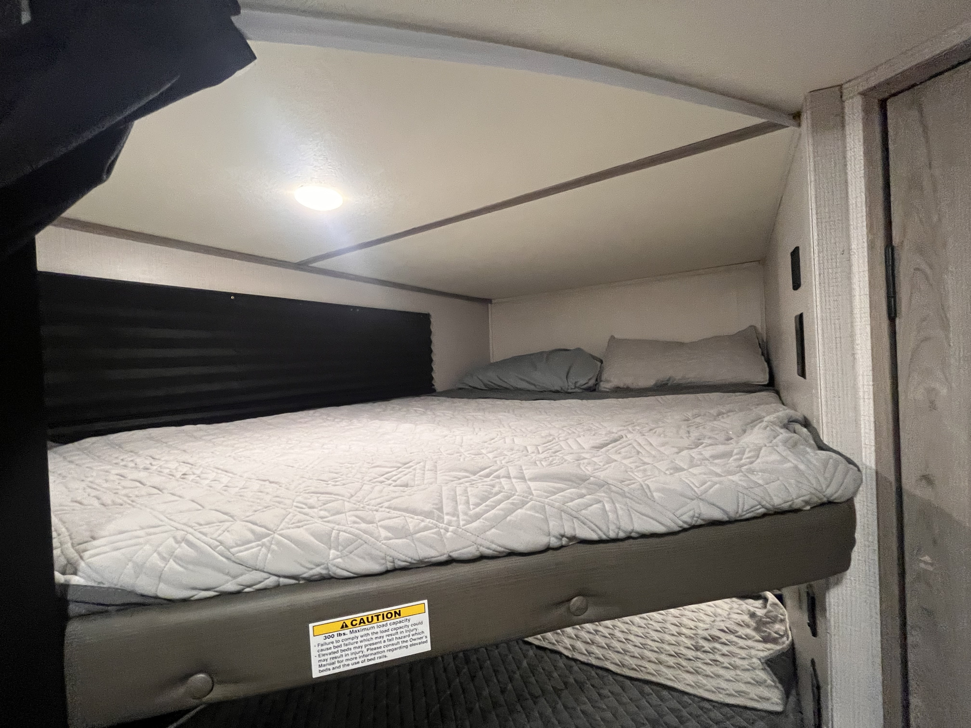 Top bunk with light and USB ports . Keystone RV Passport SL 2022
