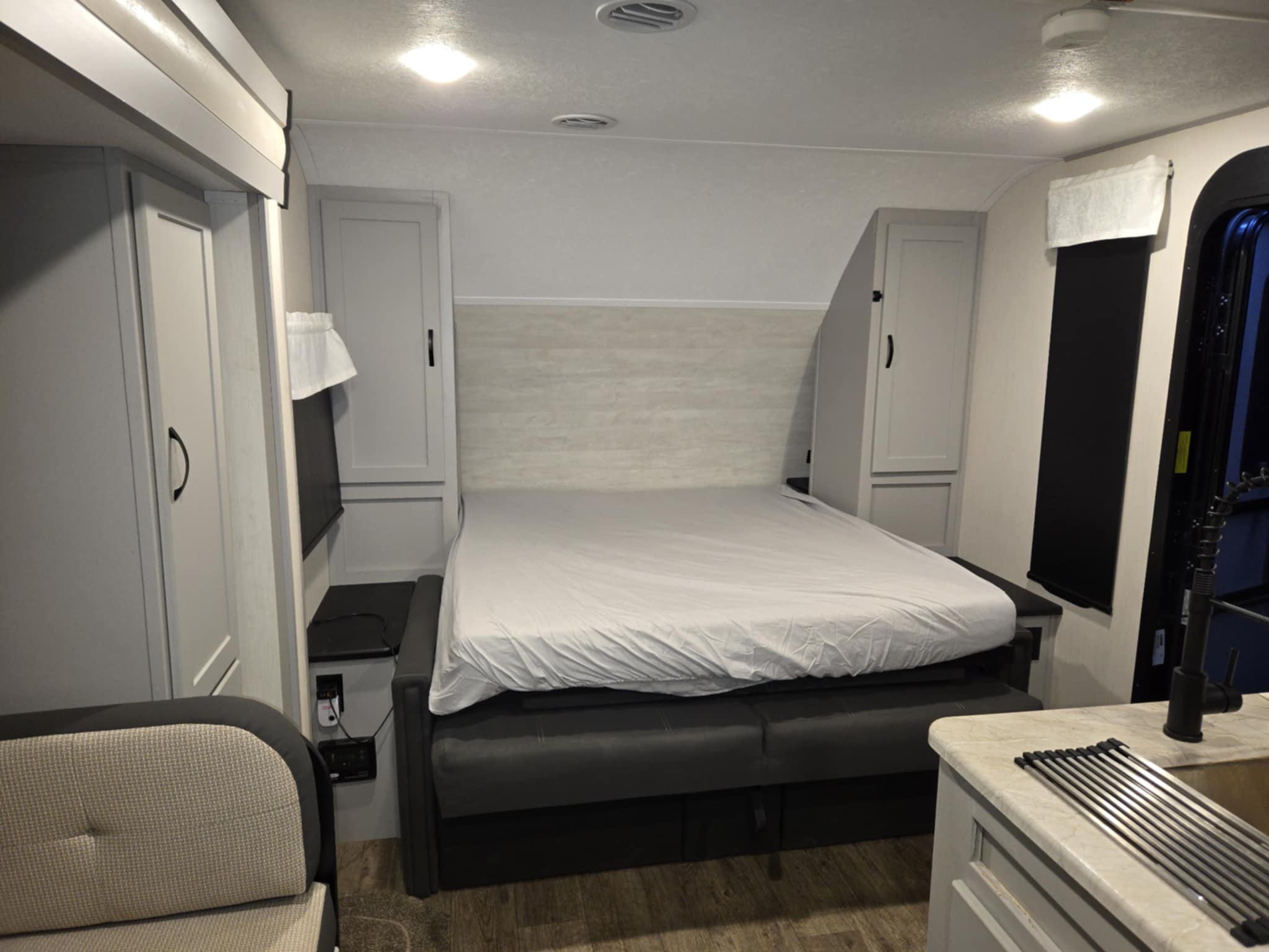 Explore this RV rental's versatile interior, featuring a bed, sofa, storage, and kitchenette for a comfortable compact living space.. Forest River Vibe 2021