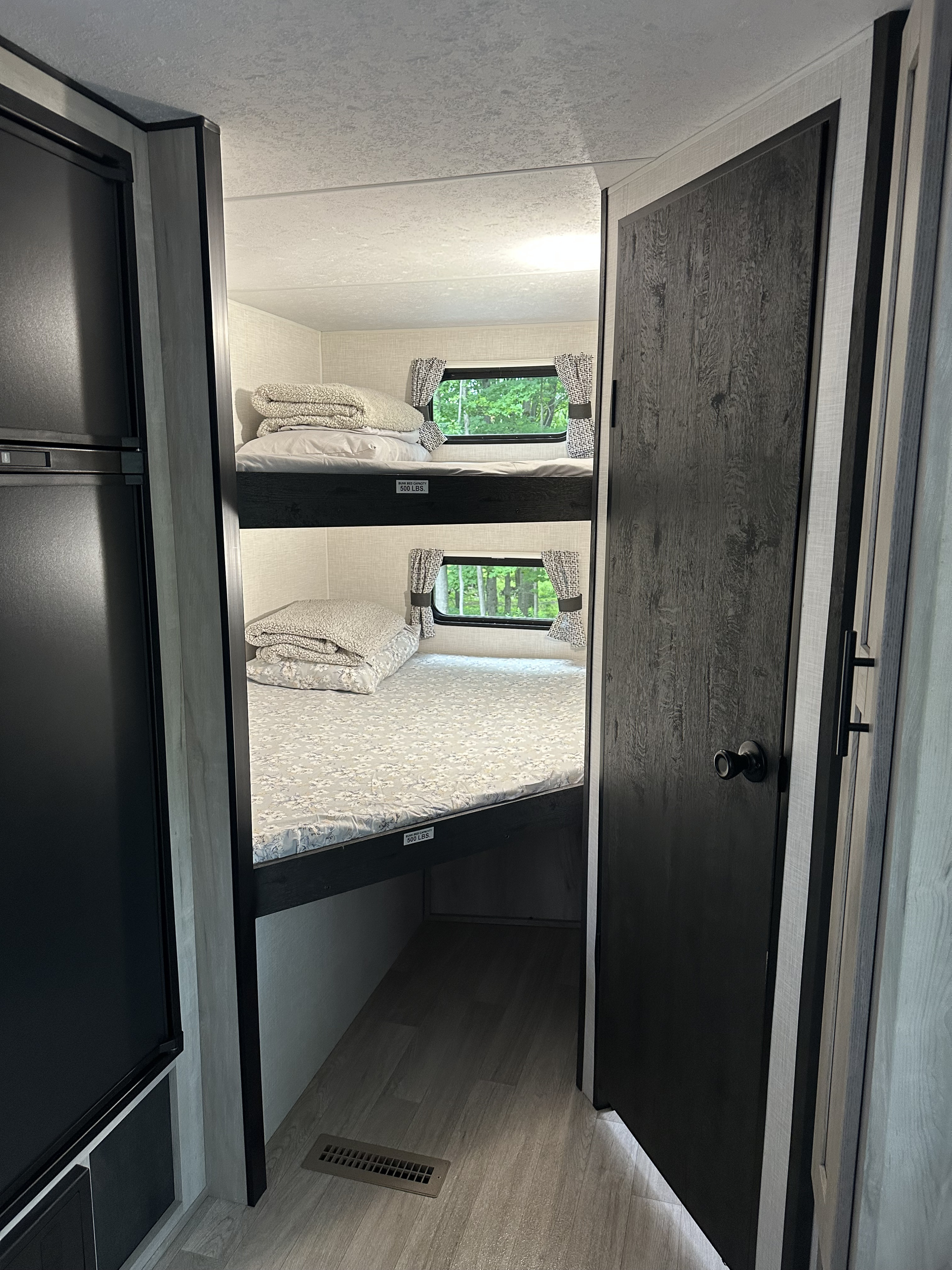 Explore this RV rental's cozy bunkhouse: two beds with windows overlooking nature, ready for a restful night's sleep on your adventure.. KZ Connect C241BHKSE 2024