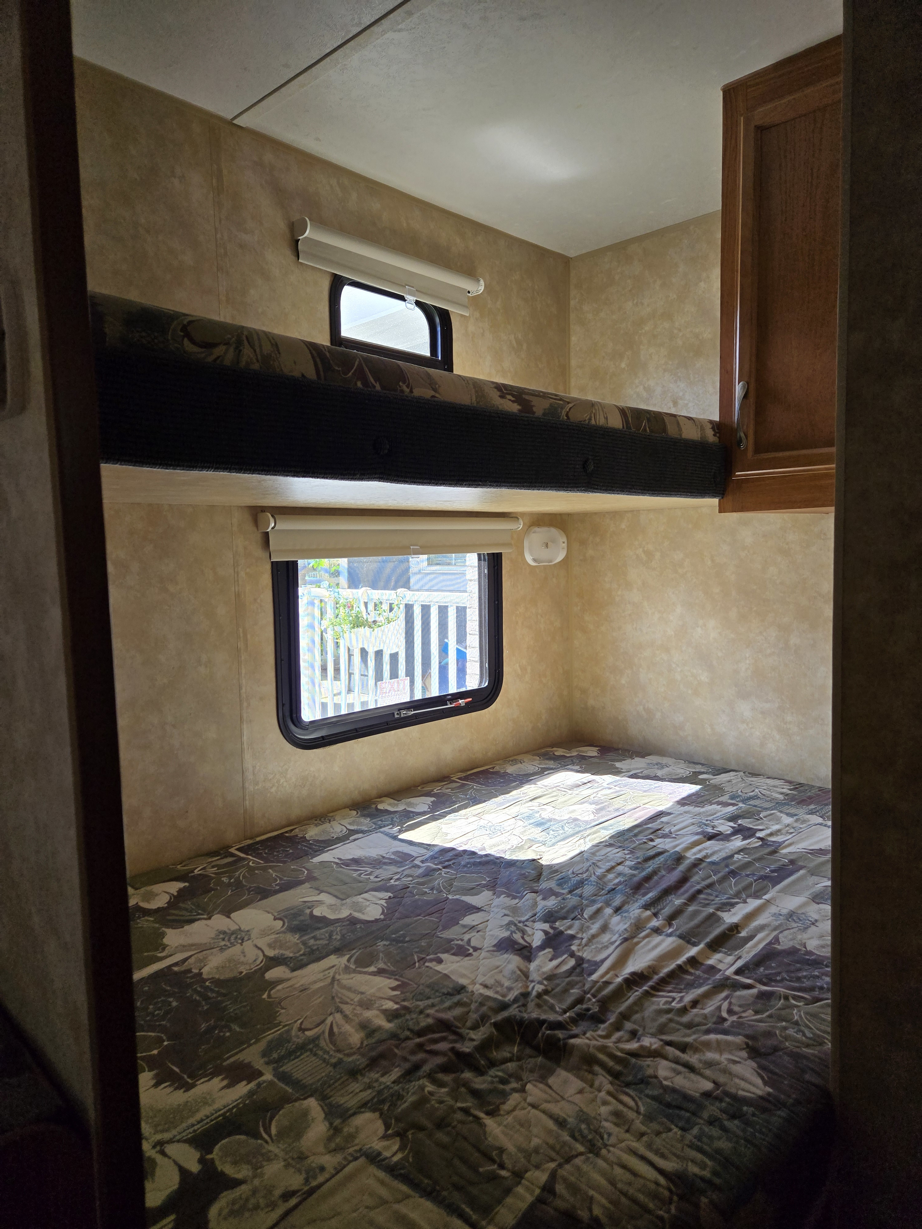 Cozy RV rental interior featuring a lower bed and upper bunk with windows, ideal for family camping adventures.. Jayco Jay Flight 2008