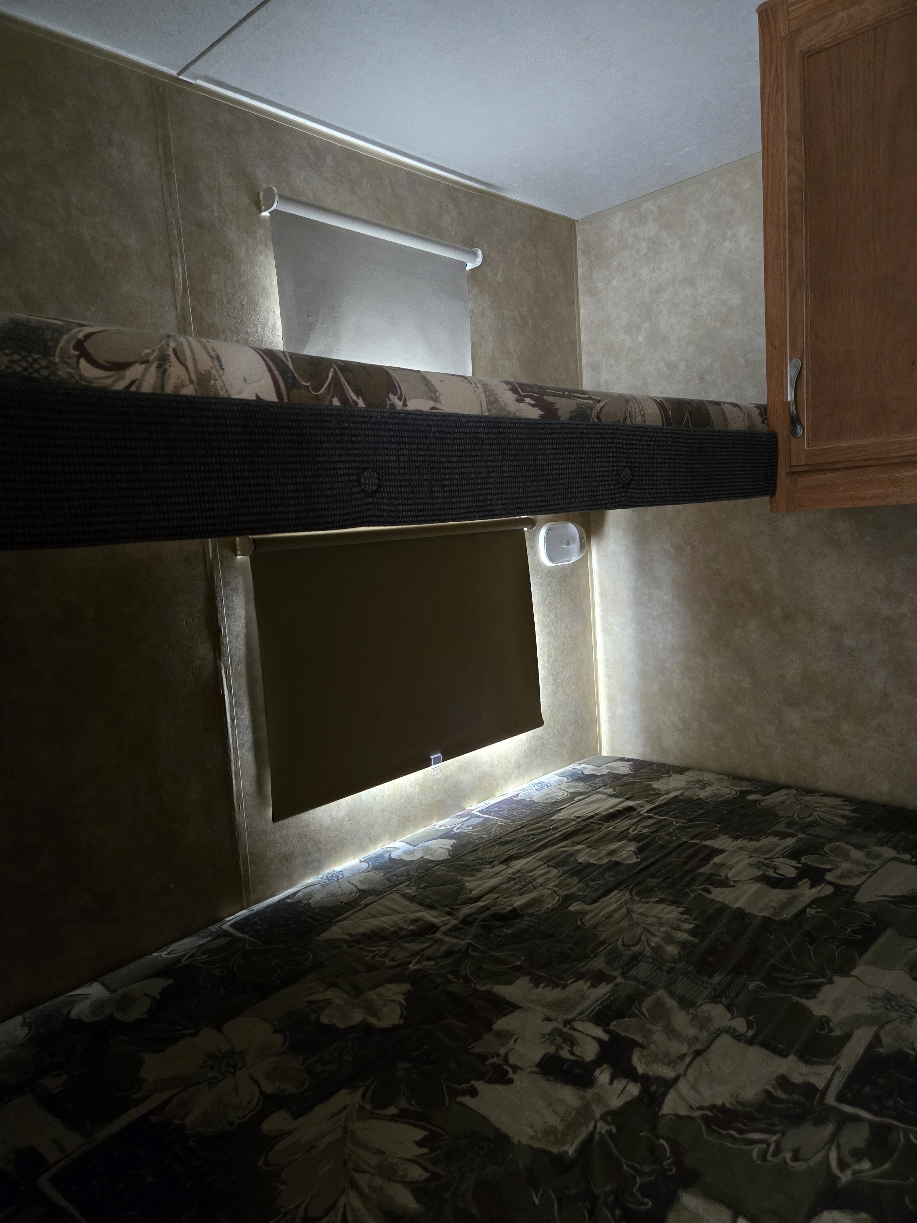 Cozy RV rental bunk beds visible inside, with patterned mattresses, roll-up shades, and ambient wall lighting.. Jayco Jay Flight 2008