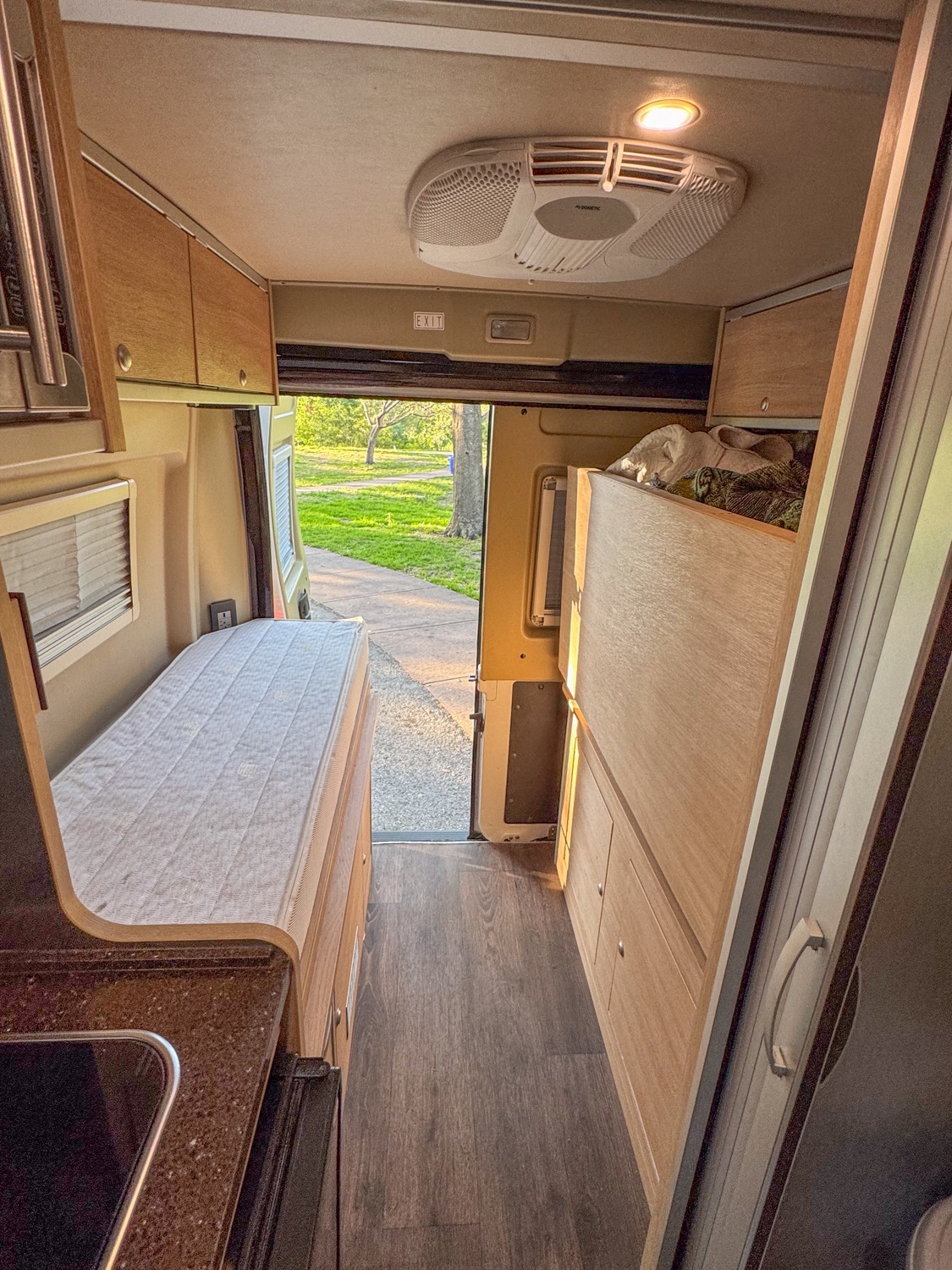 Inside an RV rental: a modern camper van setup with bed, kitchen, storage, and AC unit. Perfect for road trips.. Hymer Ayers Rock 2018