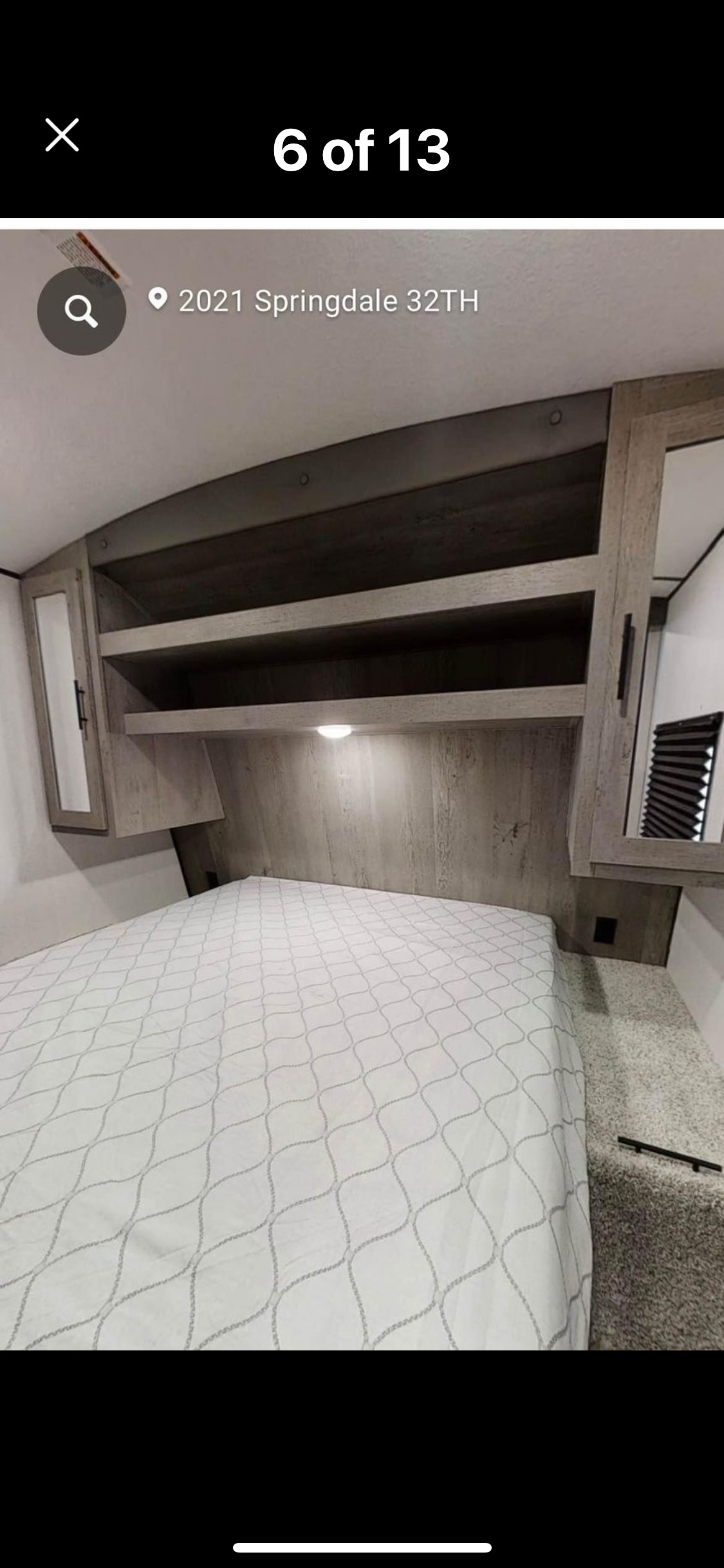 2021 Springdale 32TH RV rental bedroom featuring a comfortable bed, overhead storage, and cabinets. Ready for travel.. Keystone Springdale 2021