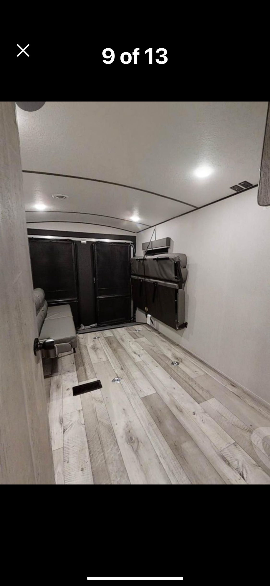 RV rental: Versatile toy hauler interior. Foldable bunk beds, bench seating, and wood-look floor provide flexible living/cargo space.. Keystone Springdale 2021