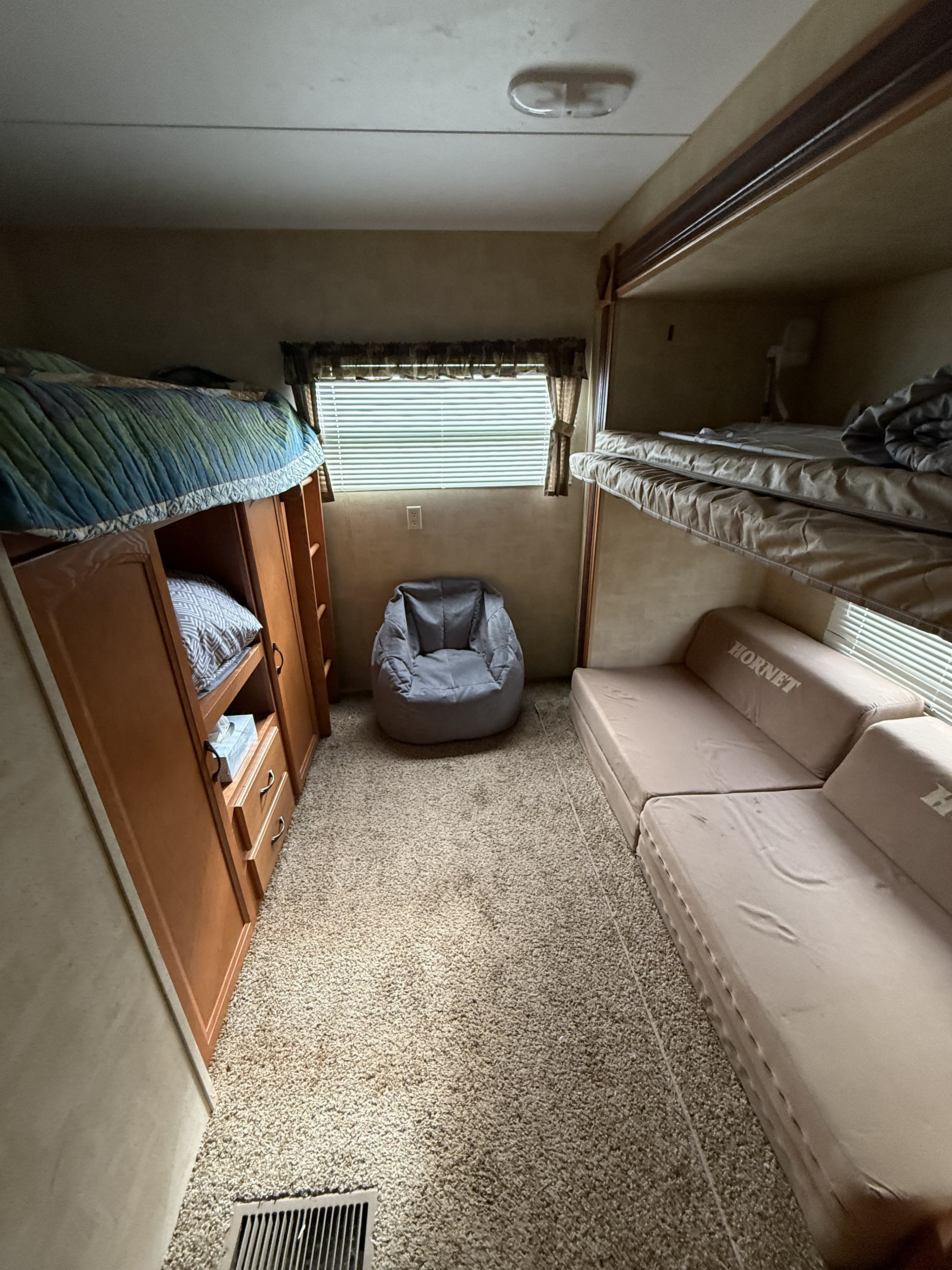 Spacious RV rental bunkhouse with multiple beds, storage, window, and a bean bag. Perfect for family trips.. Keystone RV Hornet 2011