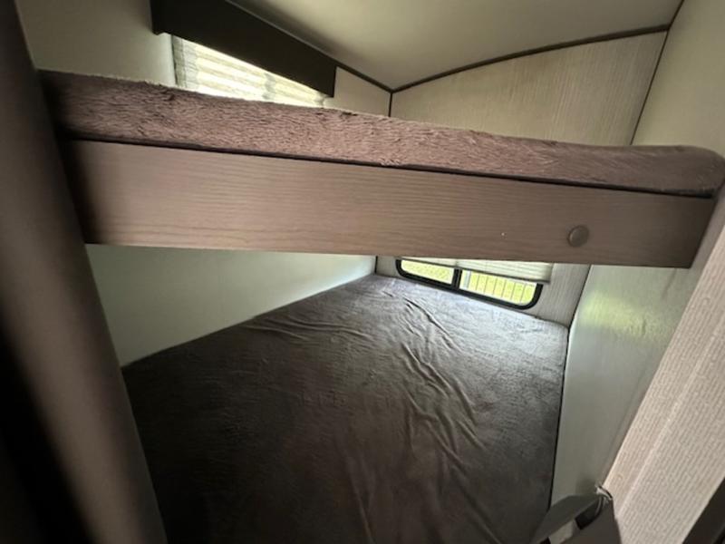 RV rental bunk beds provide comfortable sleeping space. Features an upper bunk and lower bed with a window.. Cruiser RV Shadow Cruiser 2019