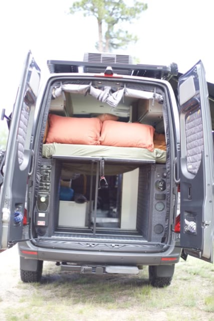 Explore the comfortable interior of this camper van RV rental, featuring a cozy bed & ample storage. Perfect for your next adventure.. Storyteller Overland Storyteller Overland Class B 2023