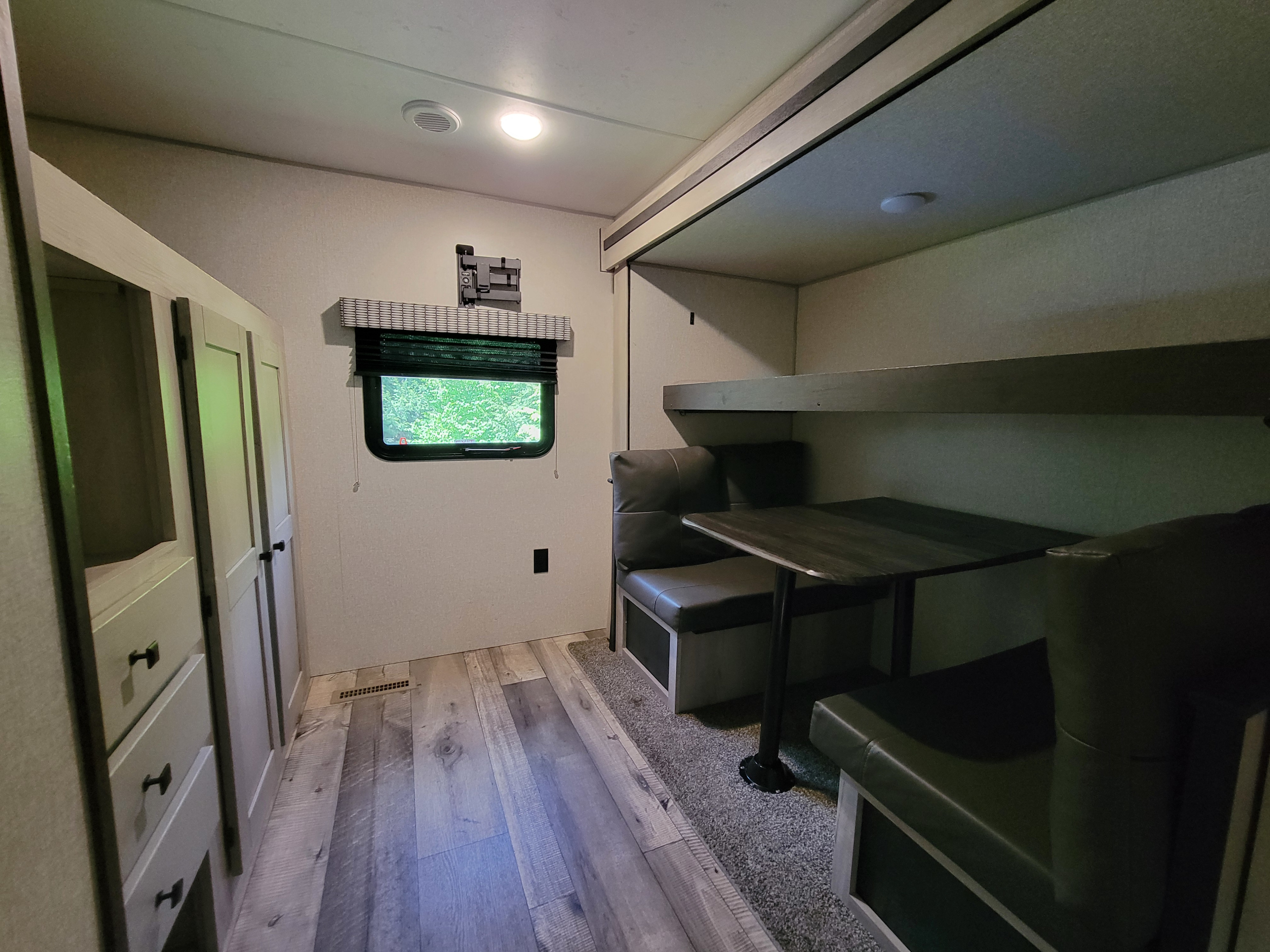Cozy RV rental interior featuring a bunk bed, dinette, and ample cabinetry for a comfortable travel experience.. Connect SE 2021