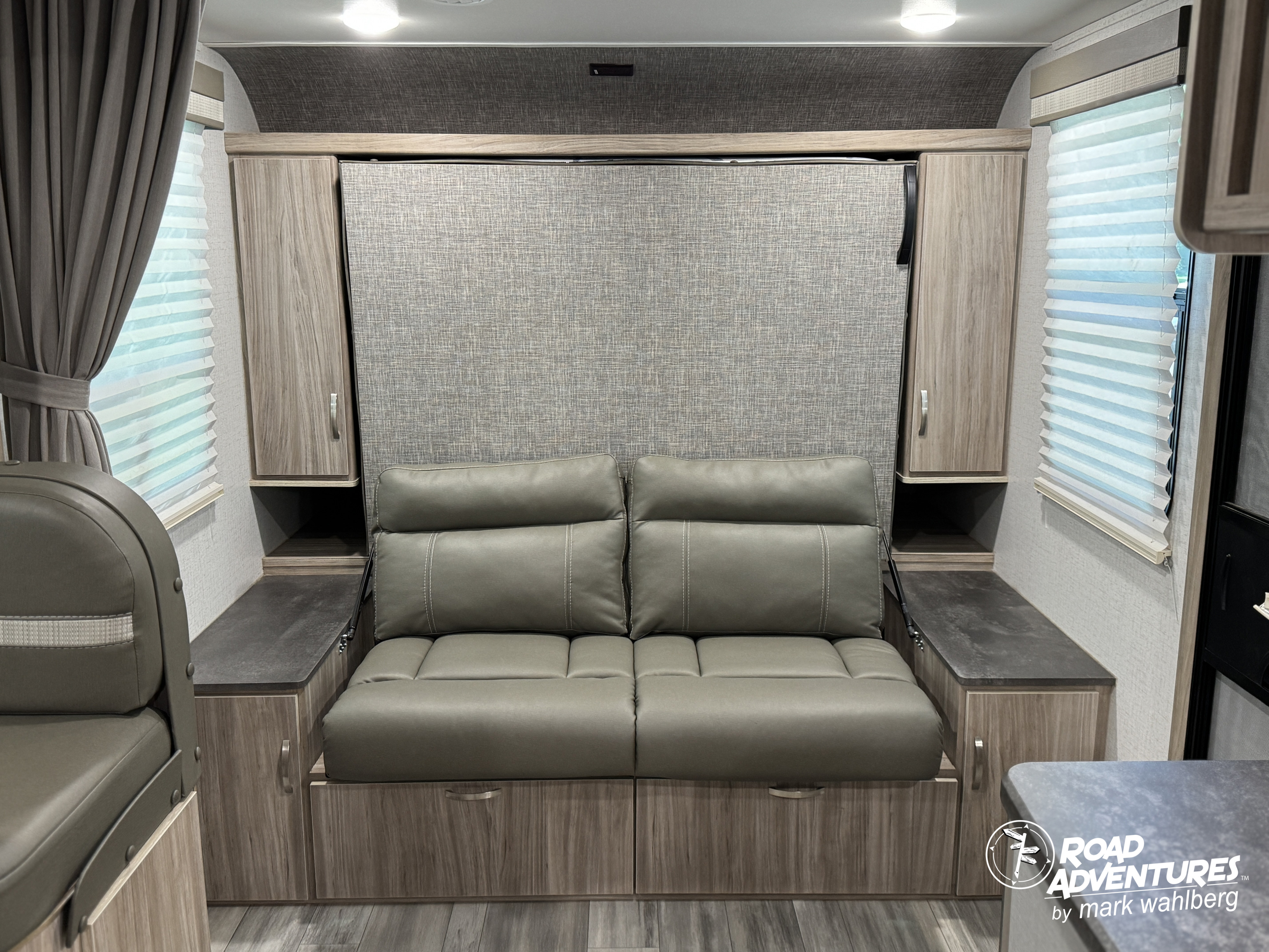 RV rental: Versatile interior featuring a comfortable sofa with a hidden murphy bed system, optimizing compact living space.. Winnebago Micro Minnie 2022