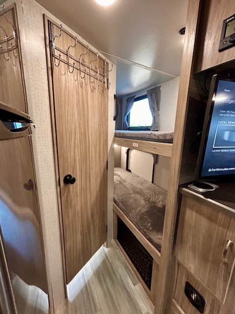 Explore this RV rental's clever interior: bunk beds, storage, and a TV for compact comfort.. Winnebago Minnie Winnie 2022