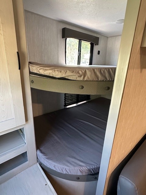 RV rental interior showing two bunk beds, with mattresses, providing compact sleeping for travel.. Forest River Forest River Viking 2025