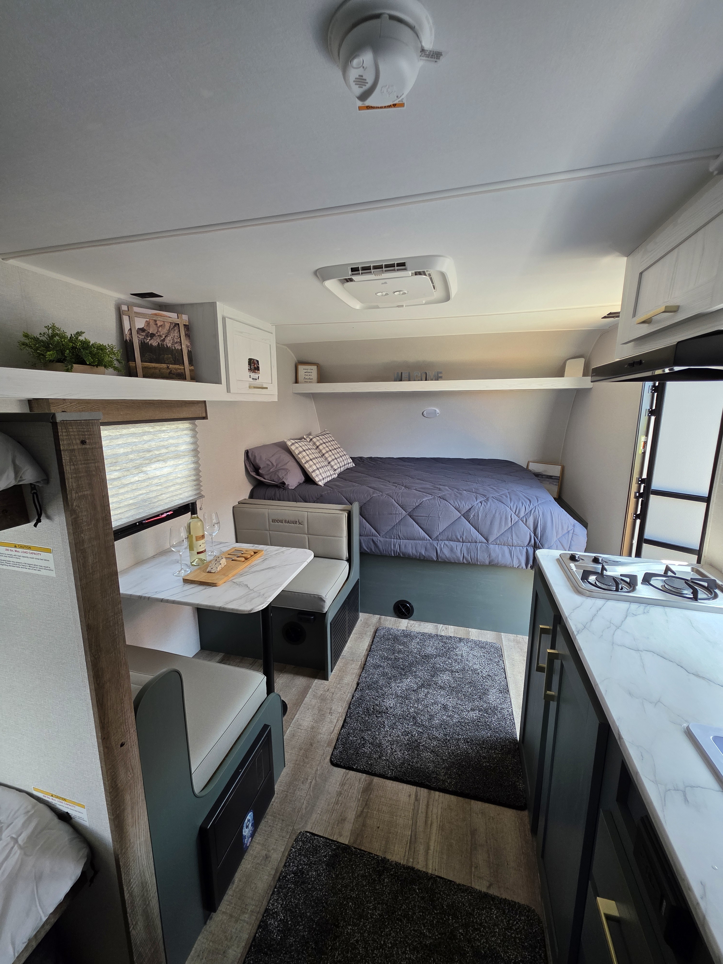 Step inside this inviting RV rental with a comfy bed, dining nook, and compact kitchen, ready for your next adventure.. Heartland Eddie Bauer 2025