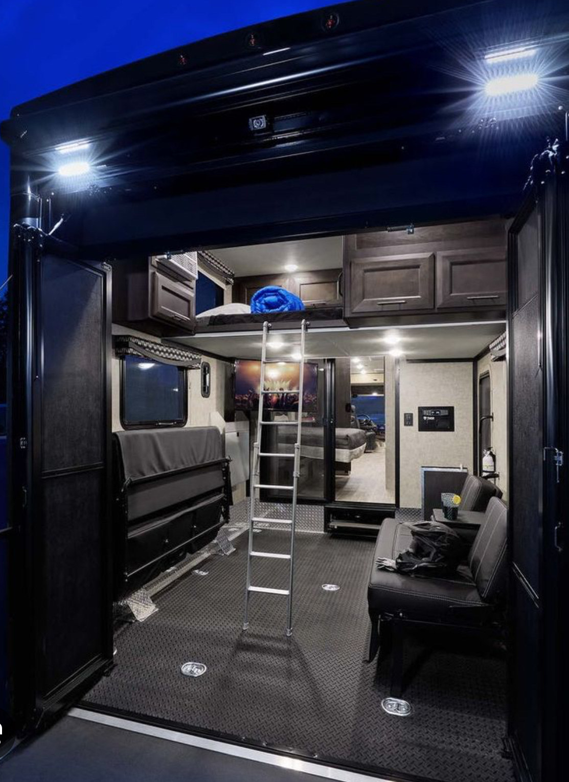 Explore this modern **rv rental**'s spacious interior with a bunk bed, versatile seating, and rugged diamond plate flooring.. Thor Outlaw 2022