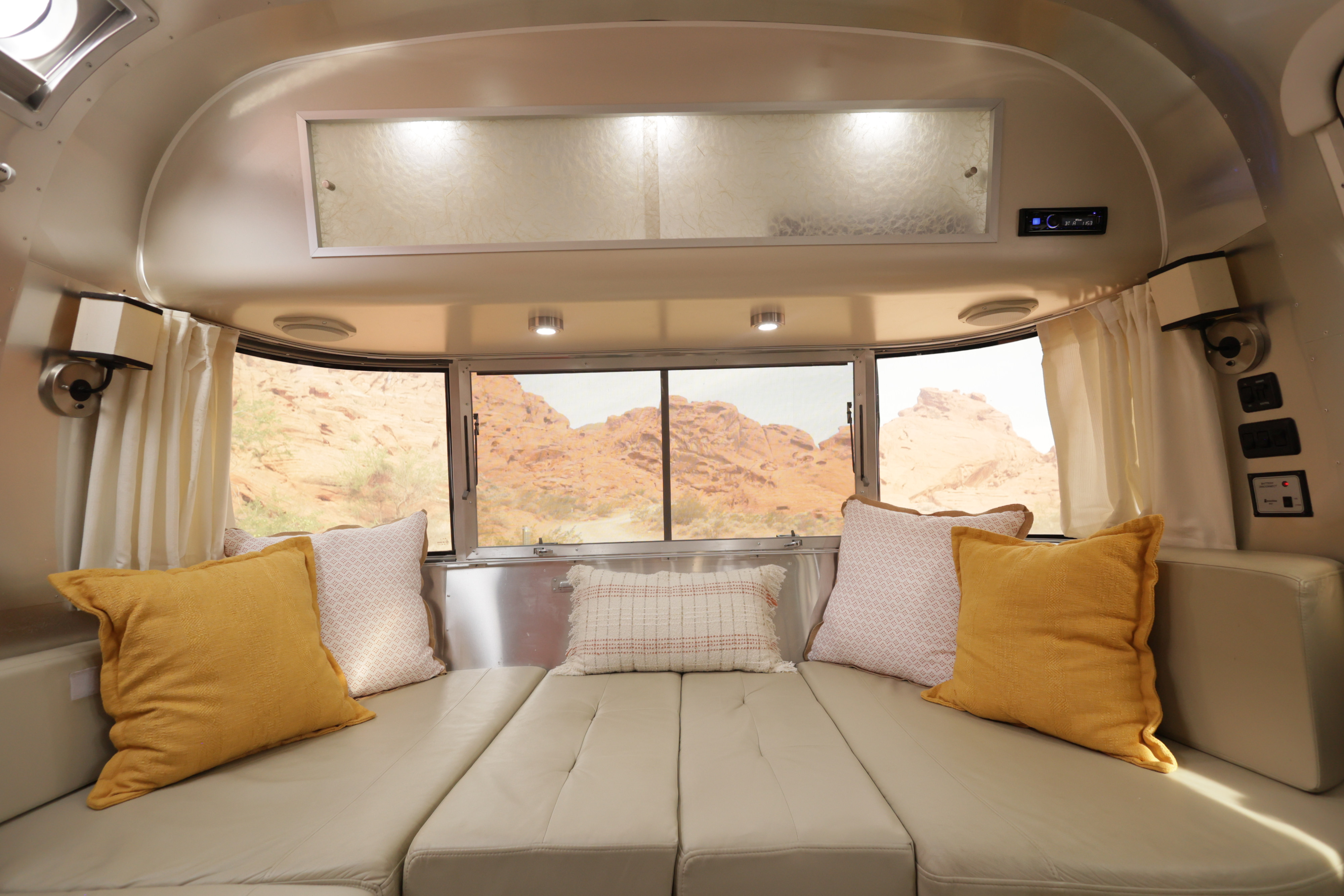 Comfortable RV rental interior offers spacious seating with desert views, ideal for your next adventure in a travel trailer.. Airstream International 2012