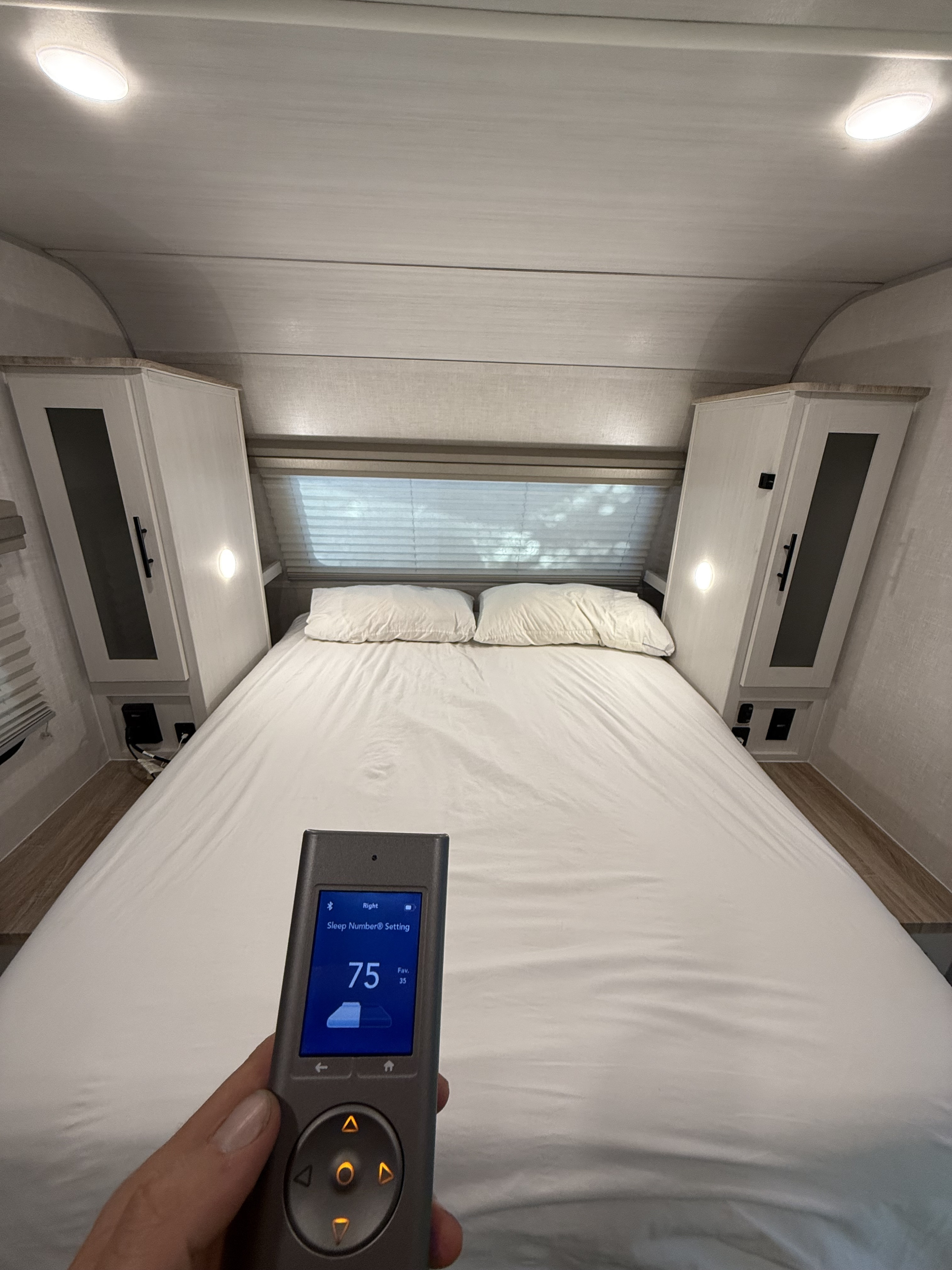 Enjoy personalized comfort in this RV rental! Adjusting the Sleep Number bed to 75 for a perfect night's sleep.. Forest River 19.3 NOBO 2023