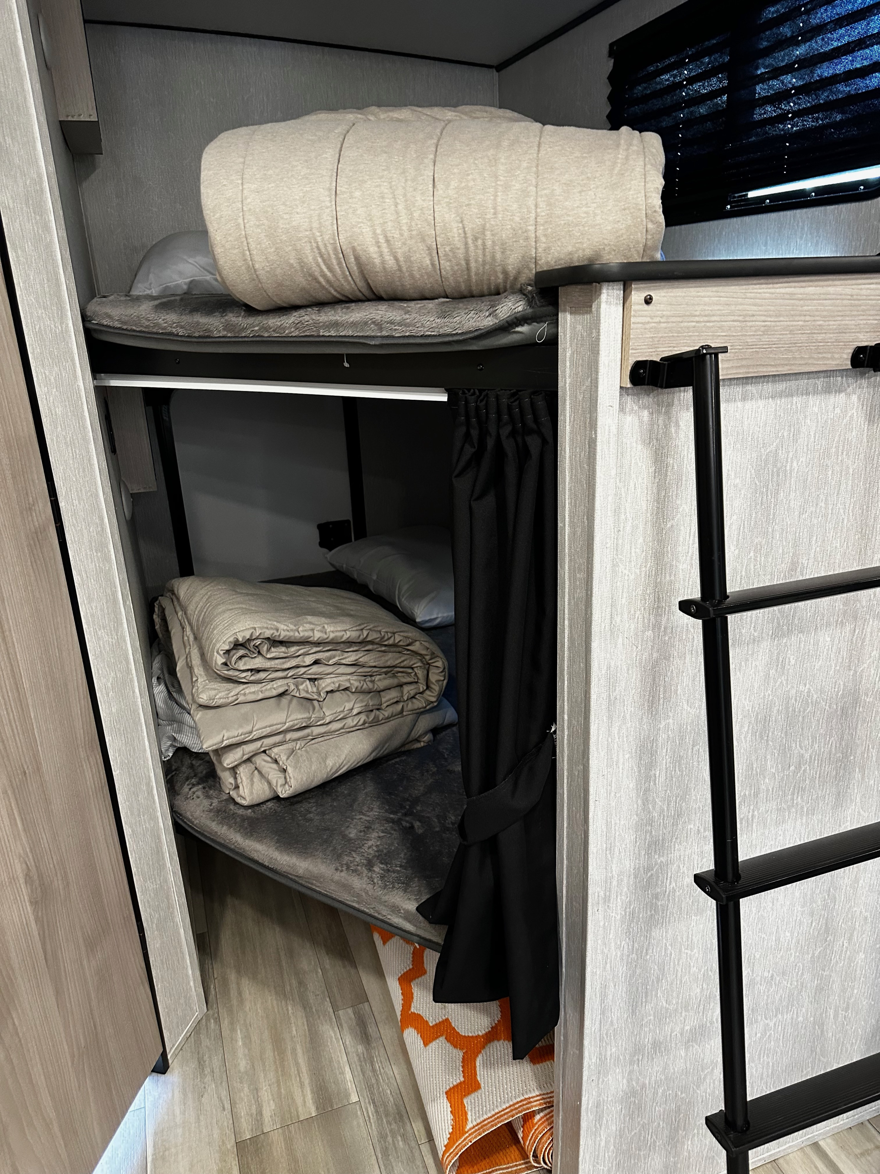 Compact RV rental: comfortable upper & lower bunk beds with bedding, privacy curtain, and sturdy access ladder.. Coachmen Spirit SBT2963BH 2022