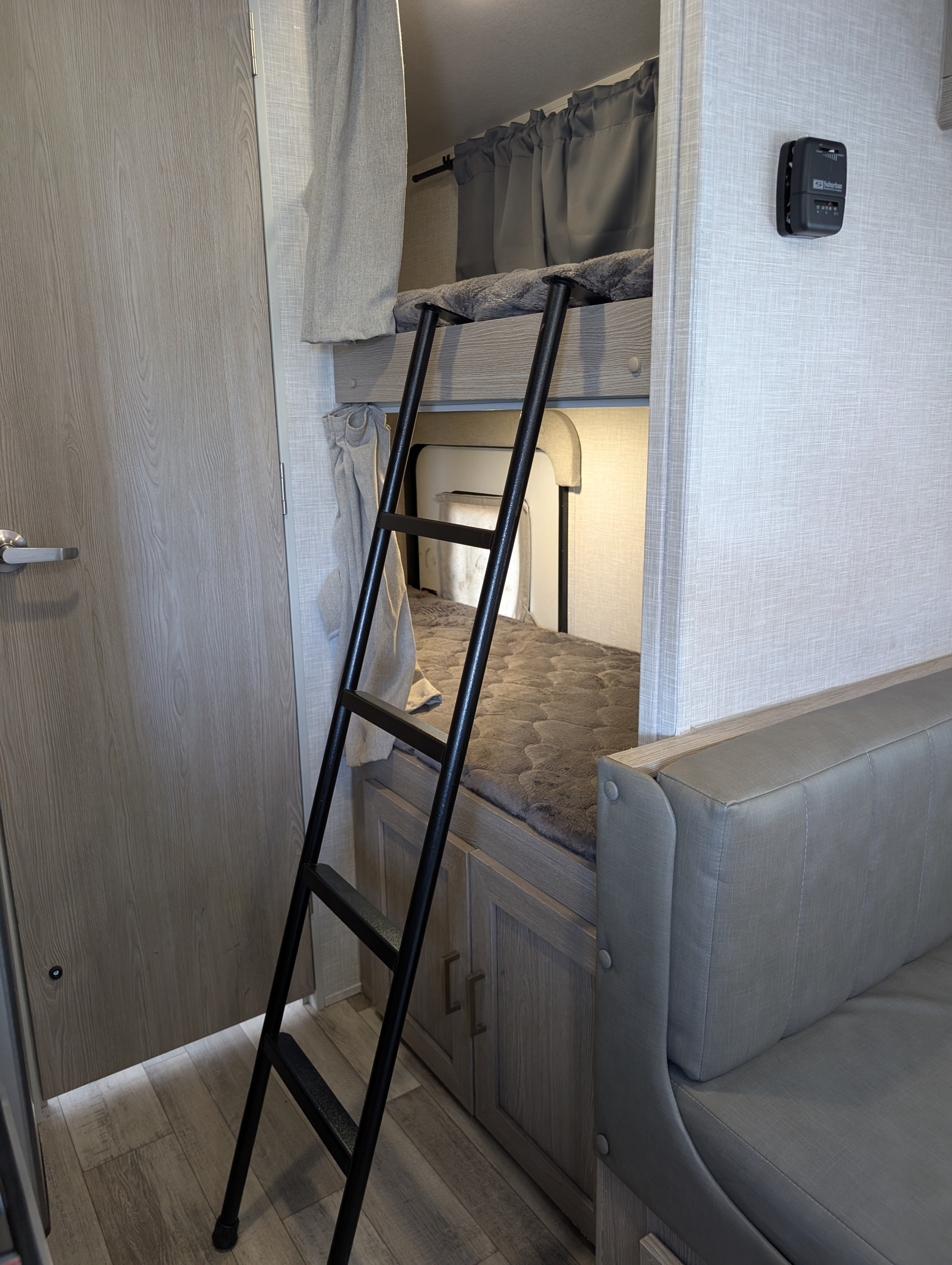 Comfortable RV rental interior showcasing bunk beds with ladder, a cozy dinette, and modern, space-saving design.. Forest River Rockwood Geo Pro 2022