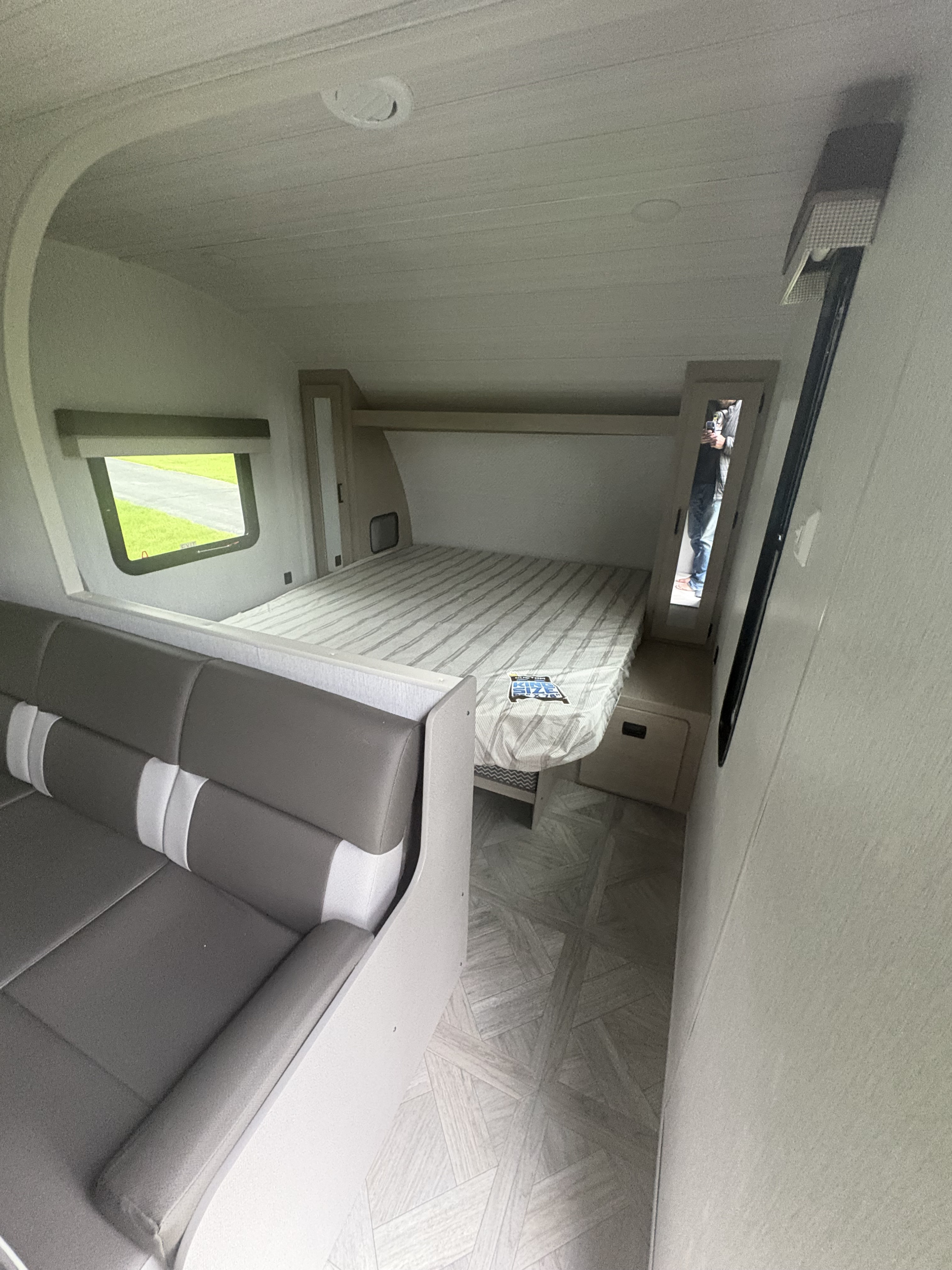 Inside this modern **rv rental**: a cozy bed, plush dinette seating, and bright interior for comfortable road trips.. Forest River Wildwood X-Lite 2023