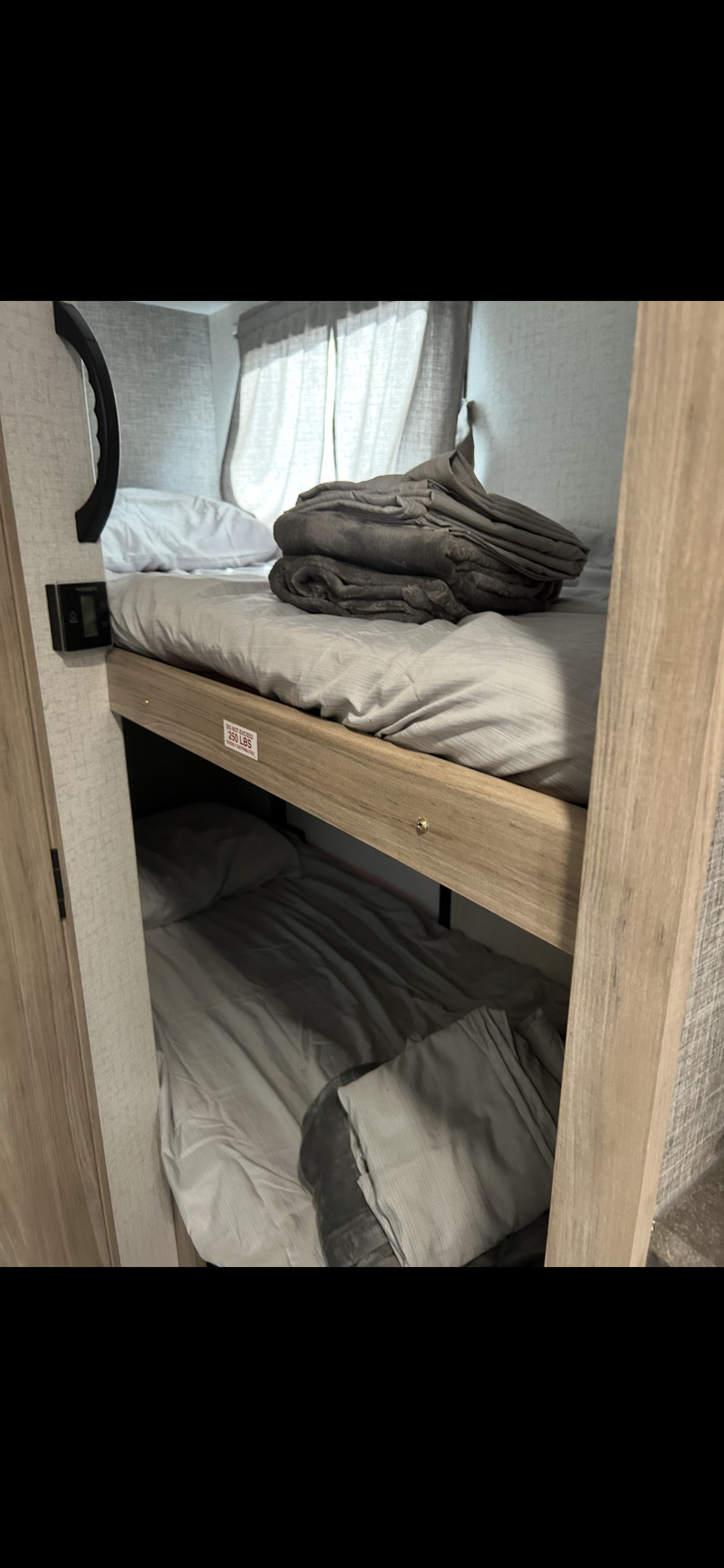 An RV rental's cozy bunk beds, featuring a 250lb limit on the top bunk. Ideal for family travel adventures.. Winnebago Micro Minnie 2021