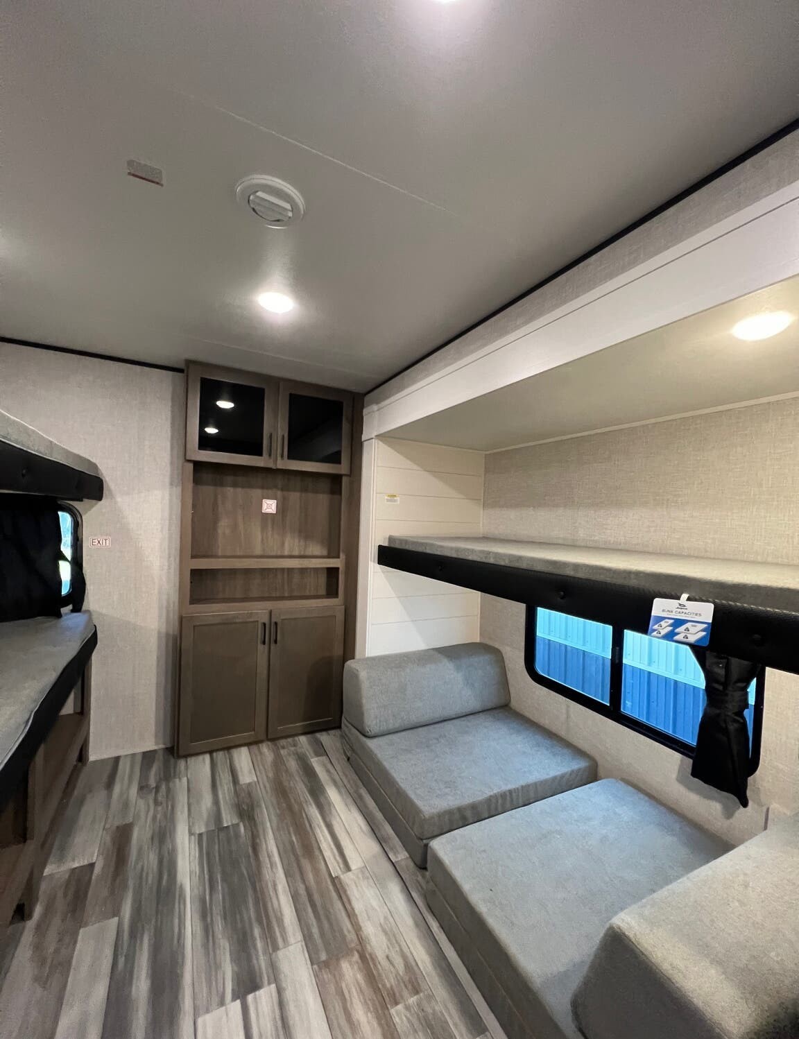 This RV rental bunkhouse features comfortable beds, convertible seating, and storage, ideal for family adventures.. 1UJBC0BT8S1YT0519 321BDS 2025